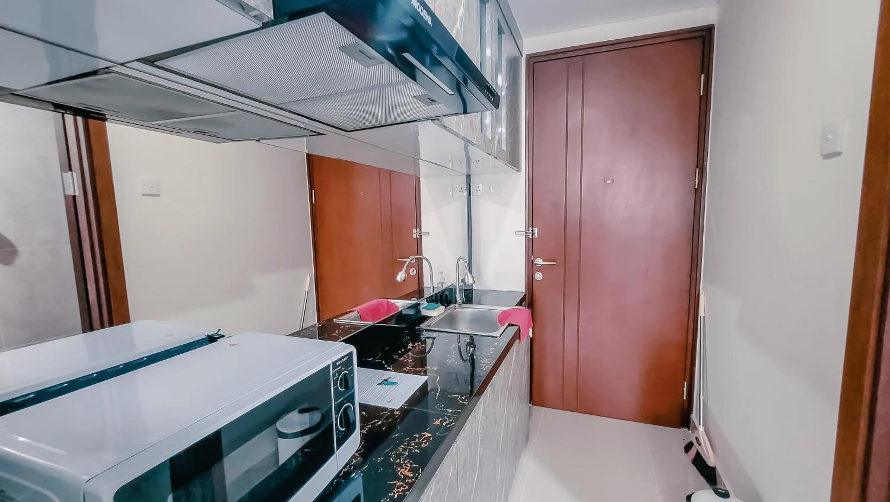 Kitchen or kitchenette in Palam Mansion at Meisterstadt Pollux Habibie Apartment