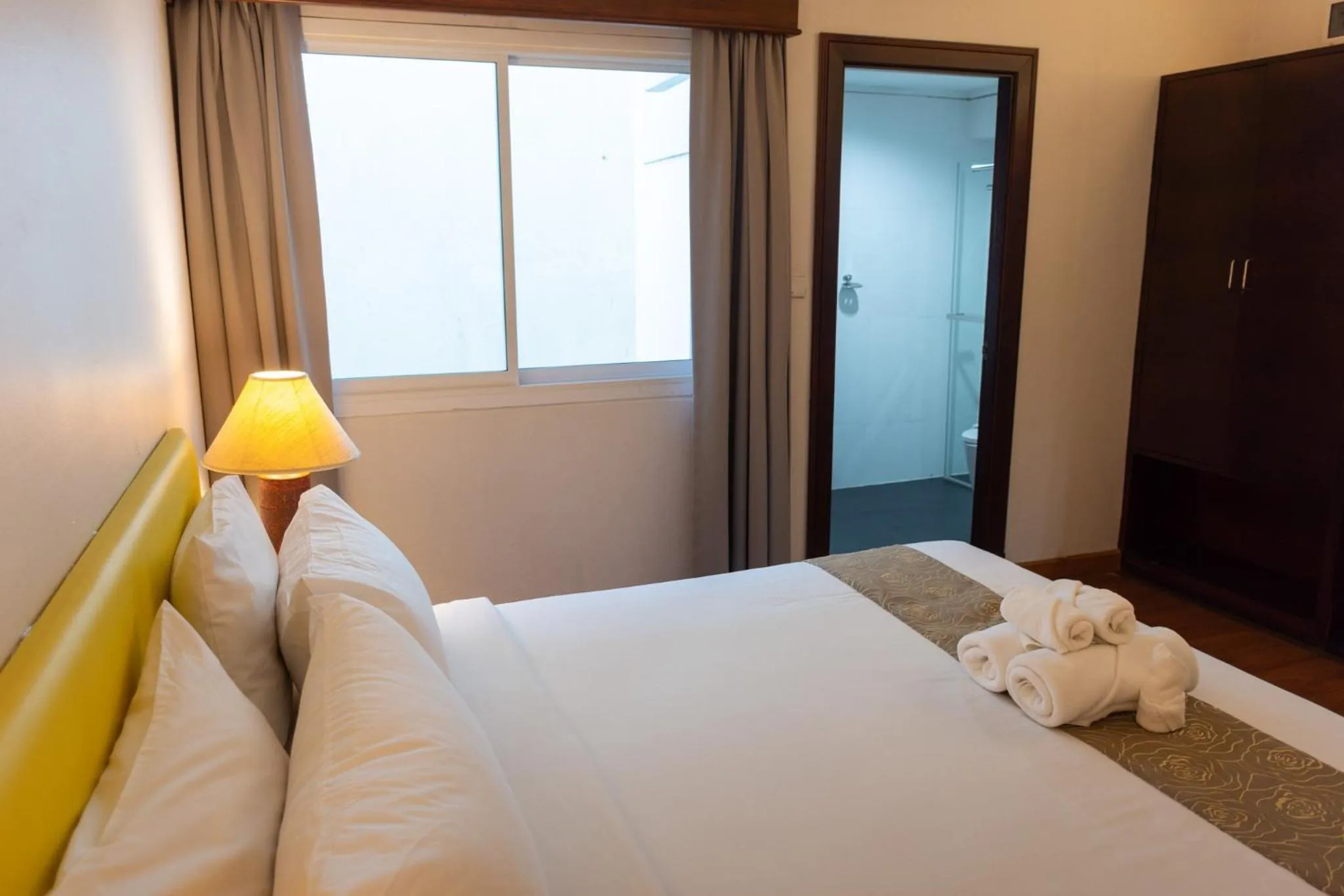 Bed in Mayflower Grand Hotel Korat