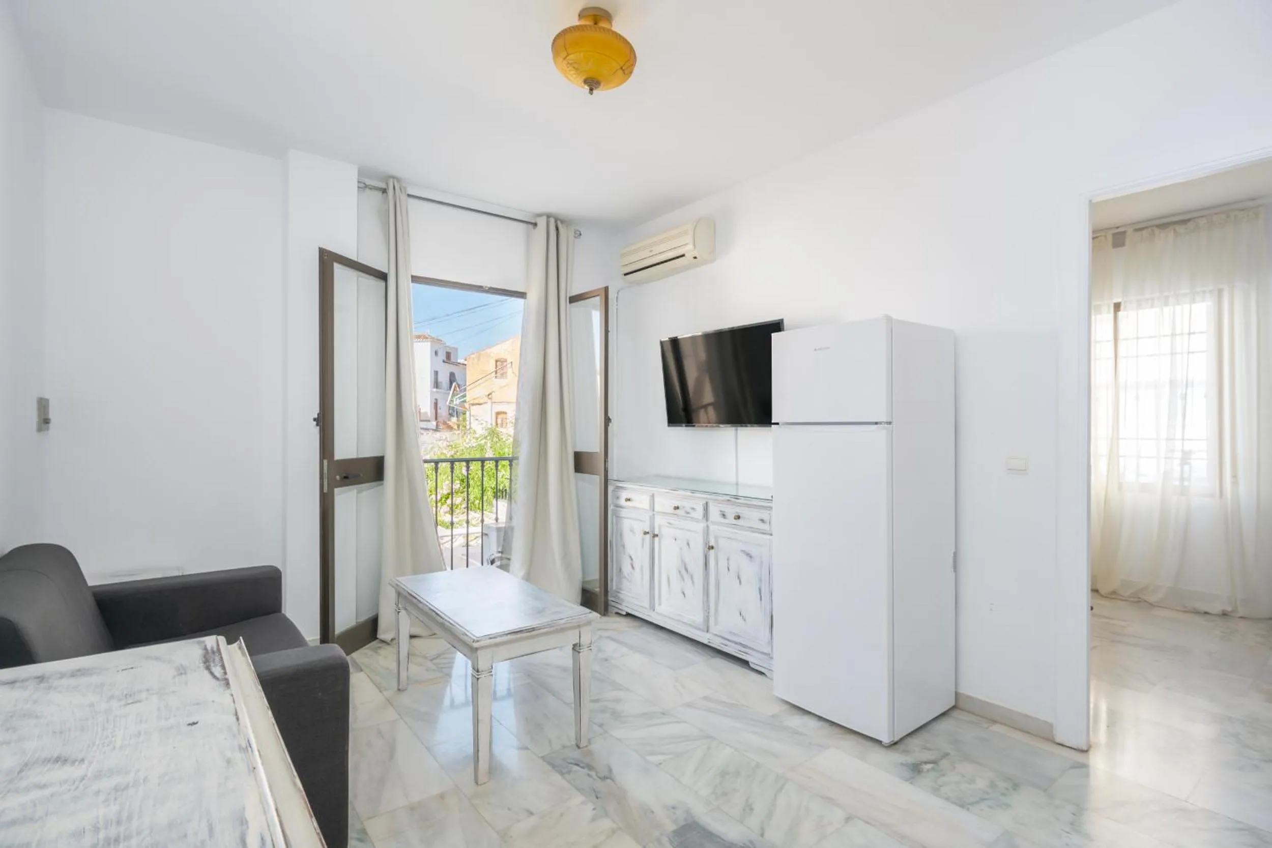 Living room in Apartahotel Playamaro by Dorobe