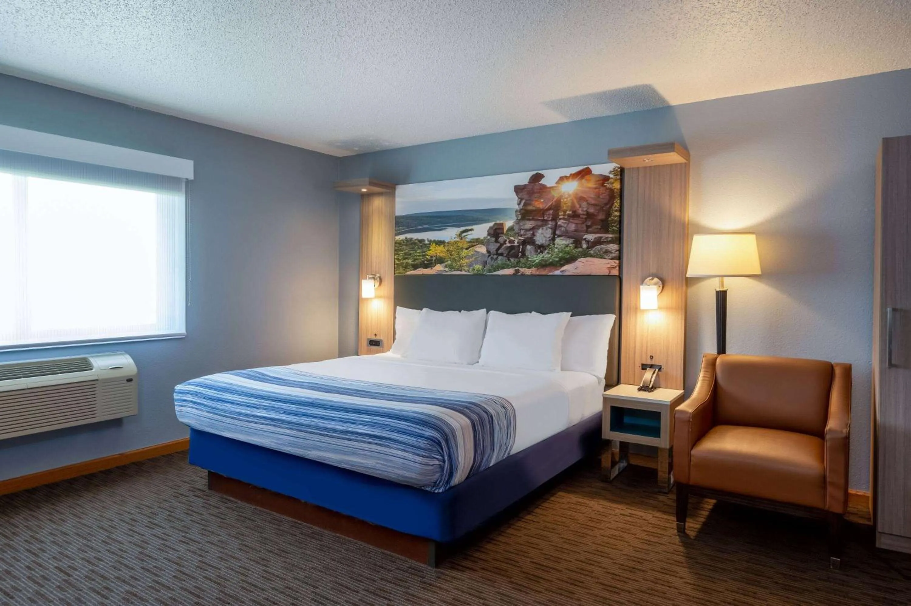 Bed in AmericInn by Wyndham Eau Claire