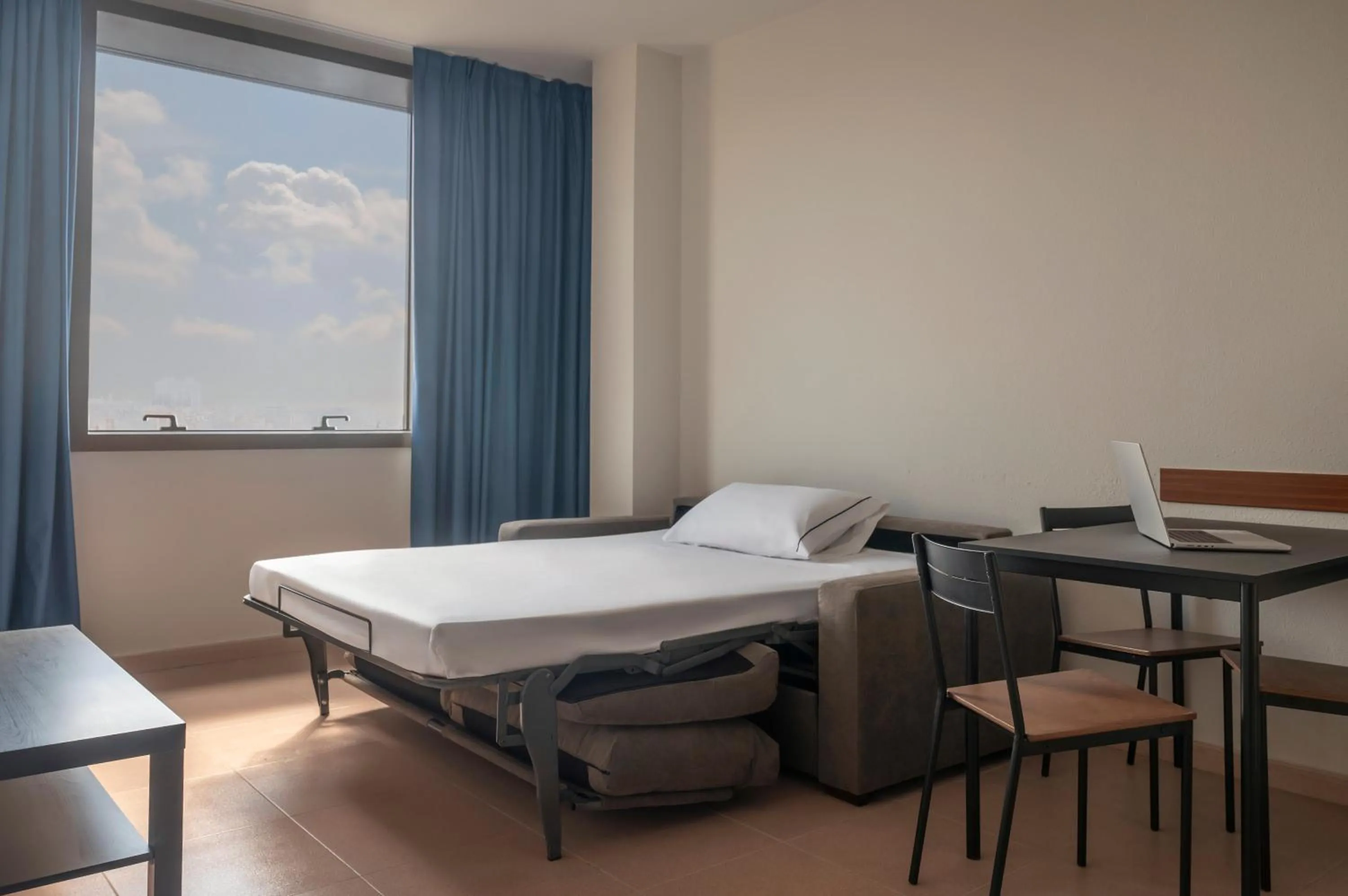 Living room, Bed in Hesperia Sant Joan