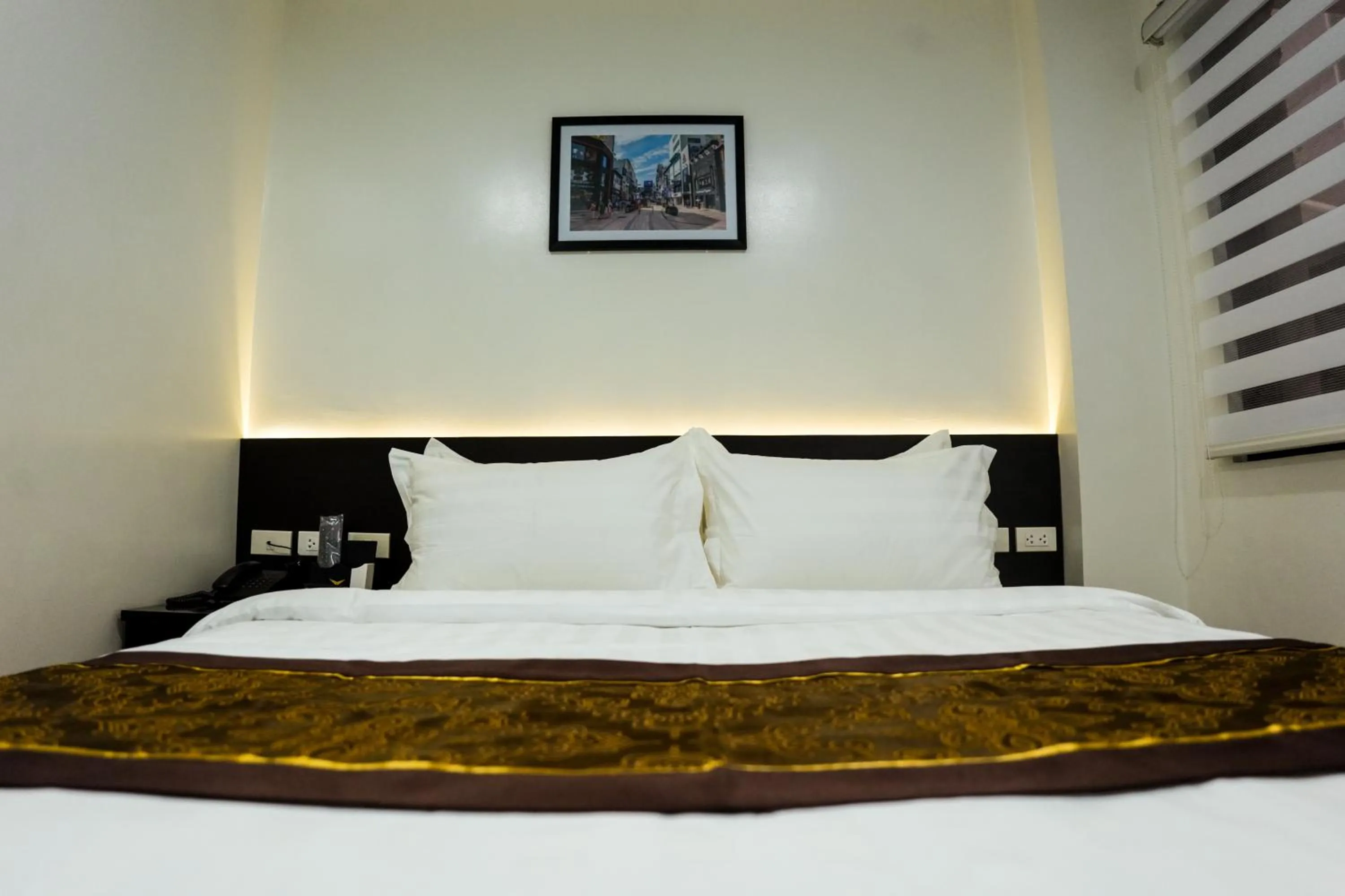 Bed in PRIMELUXE HOTEL