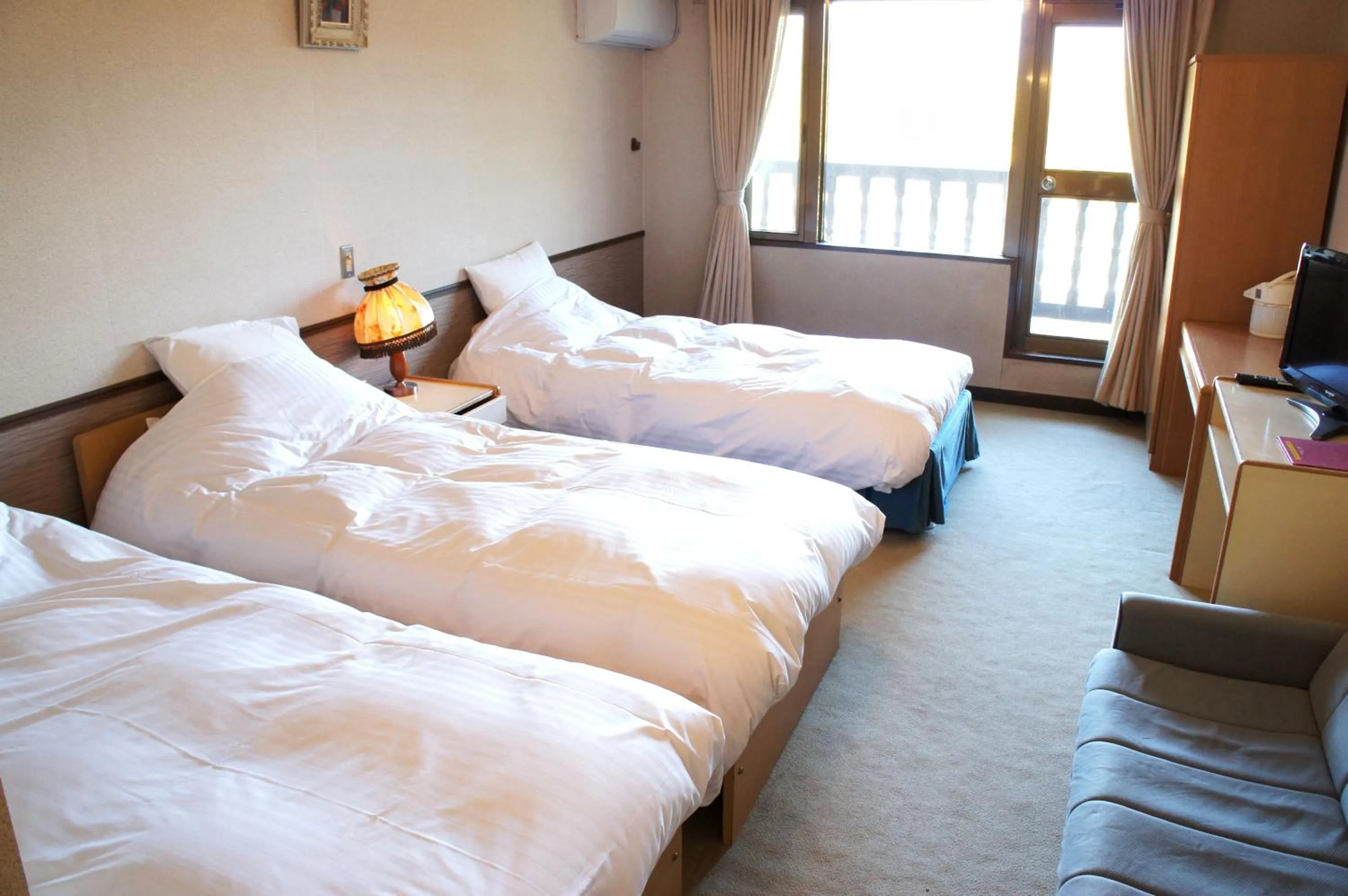 Bed in Petit Hotel Shitaka