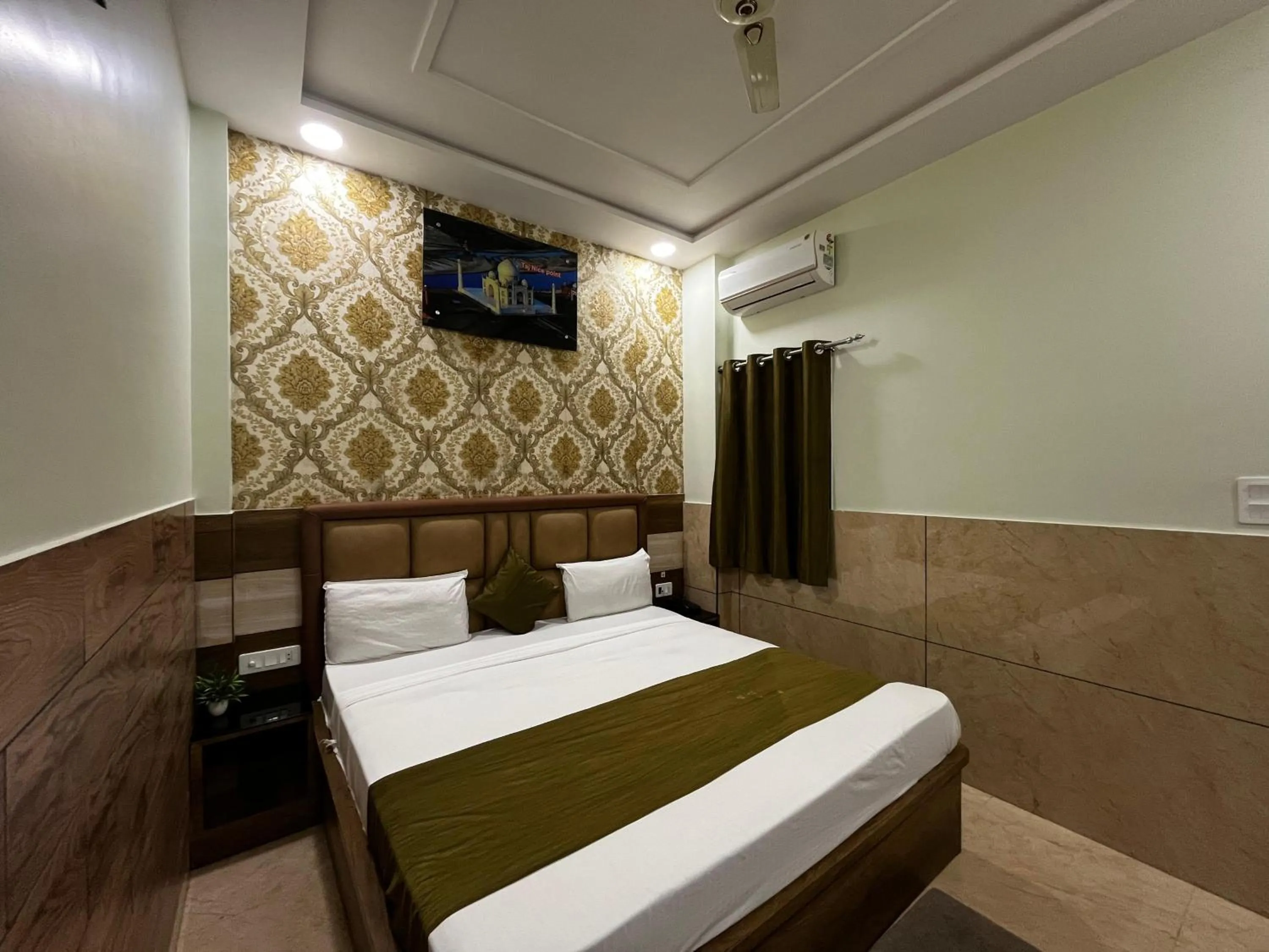 Photo of the whole room, Bed in Taj Nice Point Manage by Taj Sunrise Group