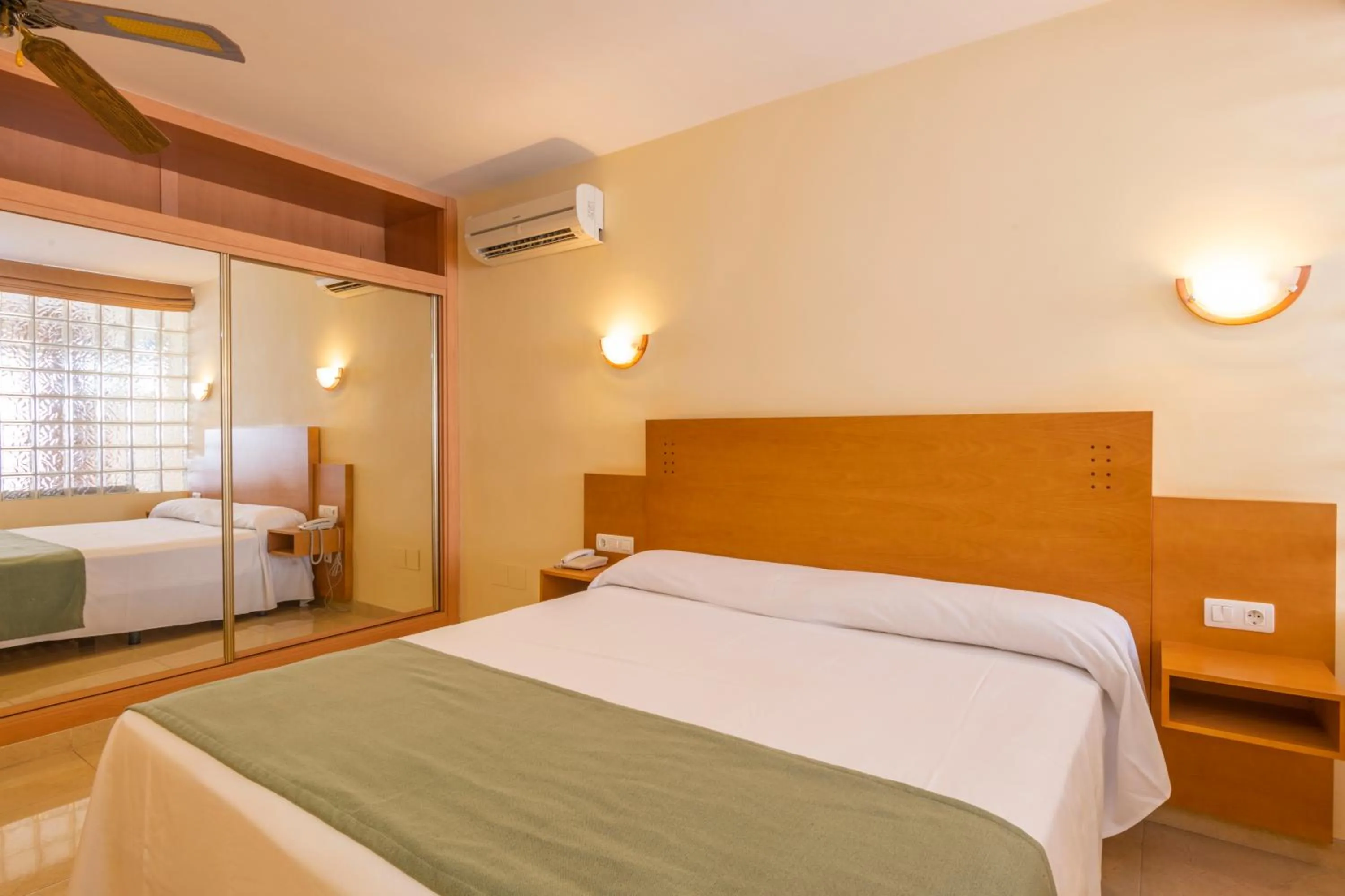 Bed in Hotel Parasol by Dorobe