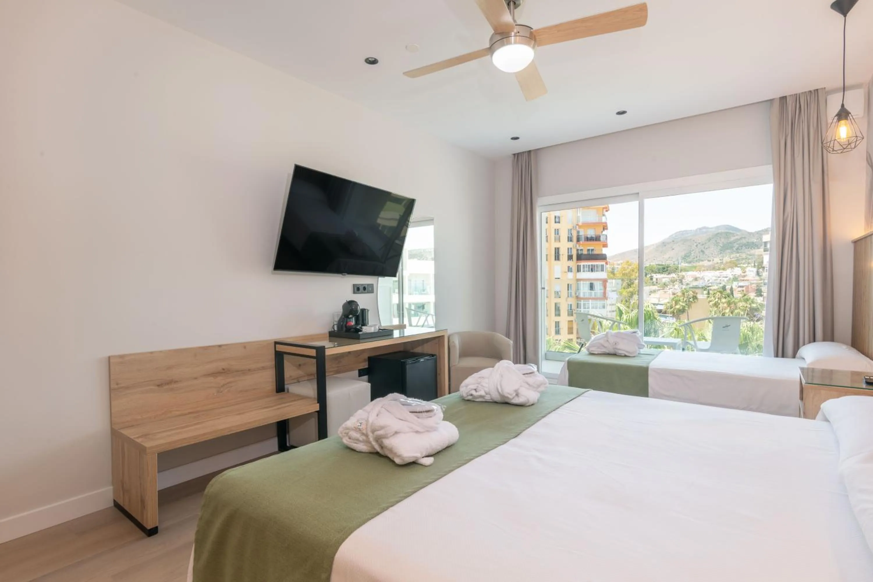 Bed in Hotel Parasol by Dorobe