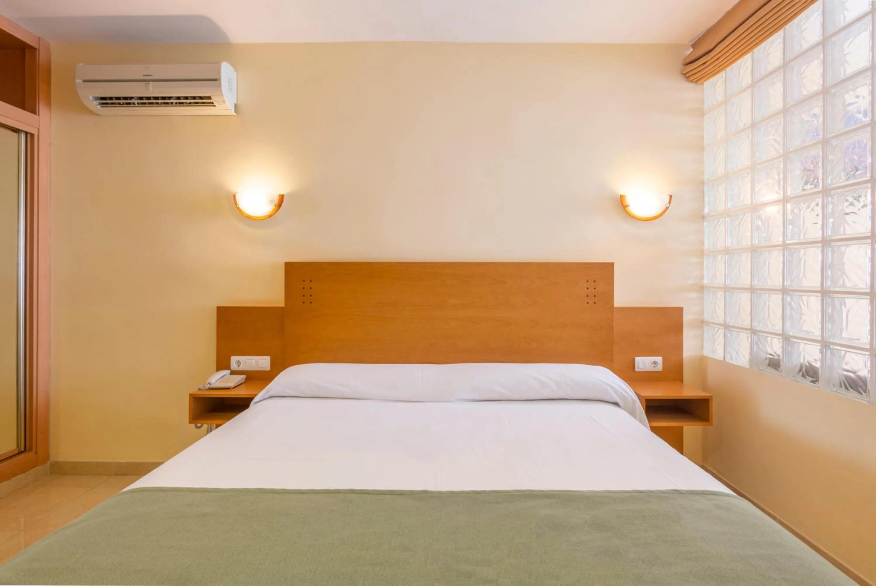 Bed in Hotel Parasol by Dorobe