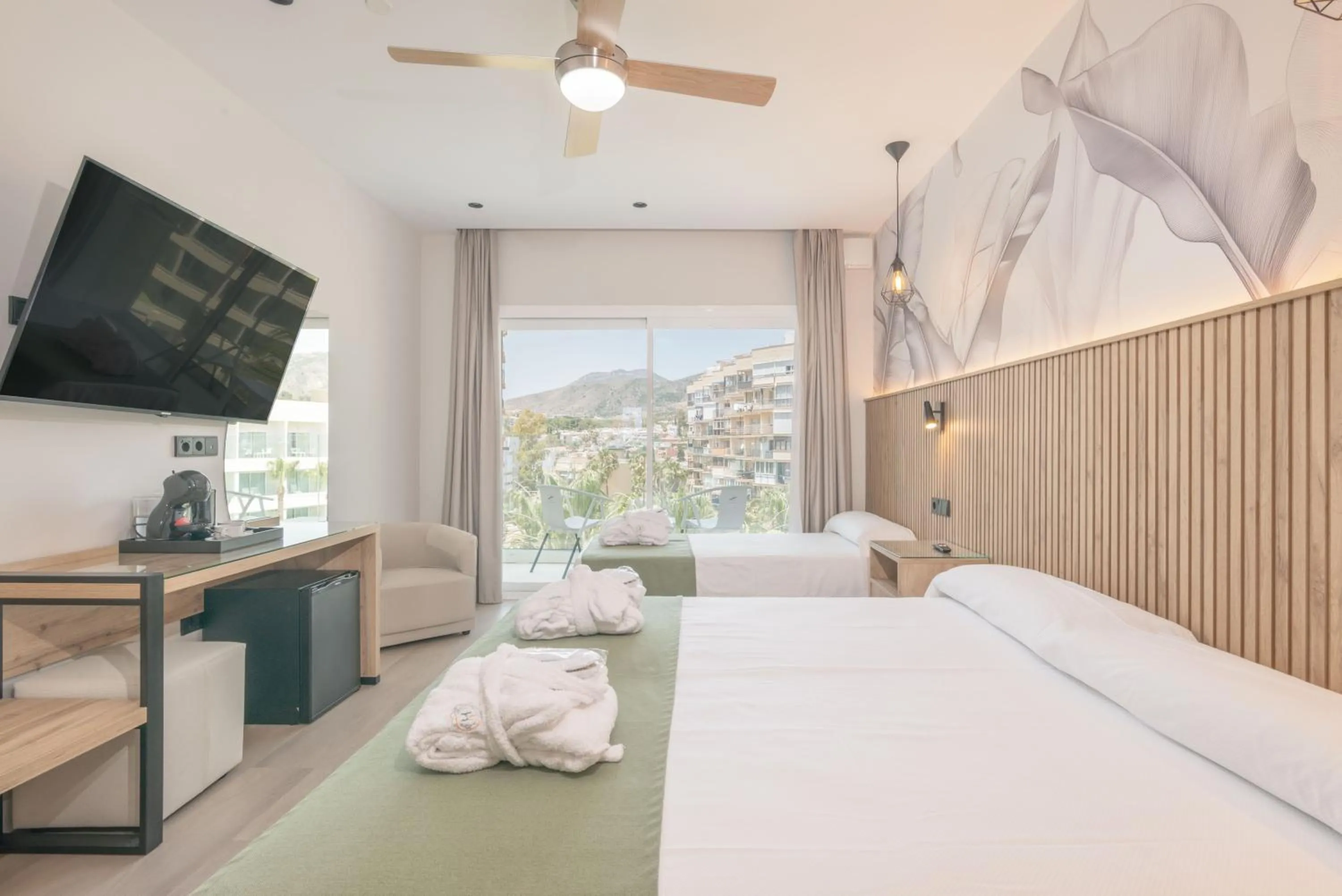 Bed in Hotel Parasol by Dorobe