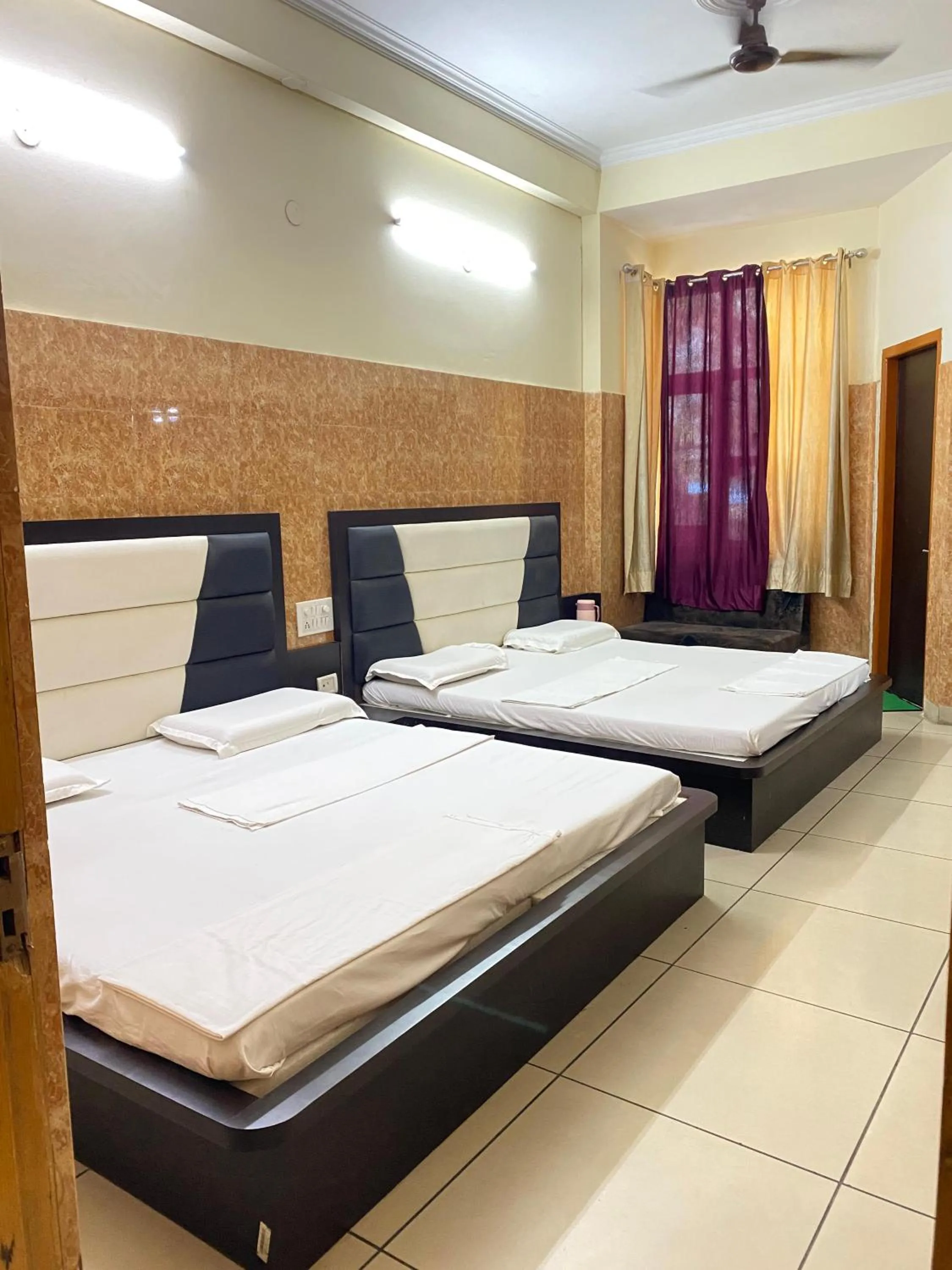 Bed in AASHIRWAD HOTEL