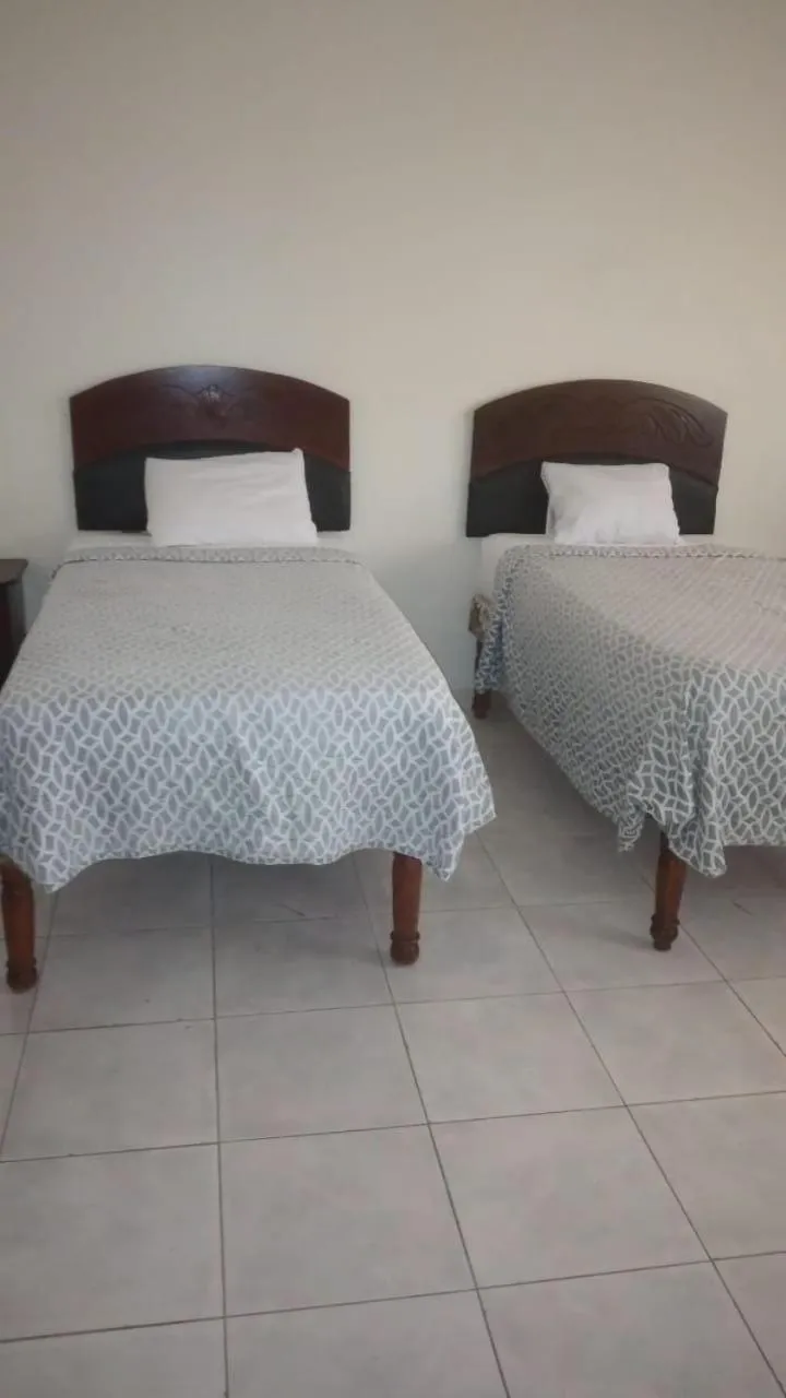 Bed in Tropical Court Hotel