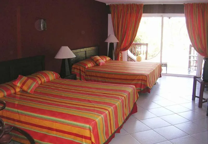Bed in Tropical Court Hotel