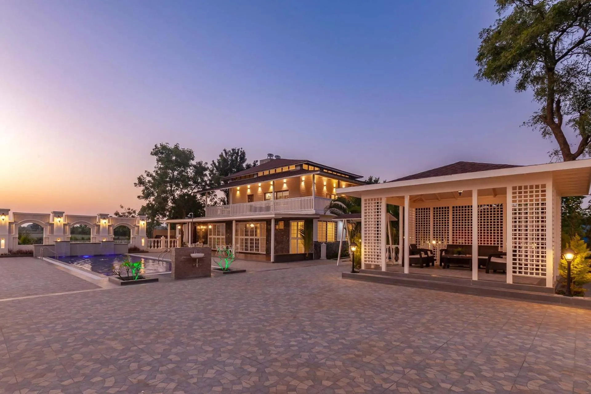 Property building in StayVista's Lake La Vie - Tranquil Lake-View Villa Amidst Farmland with Pool and Poolside Gazebo - Proximity to Sula