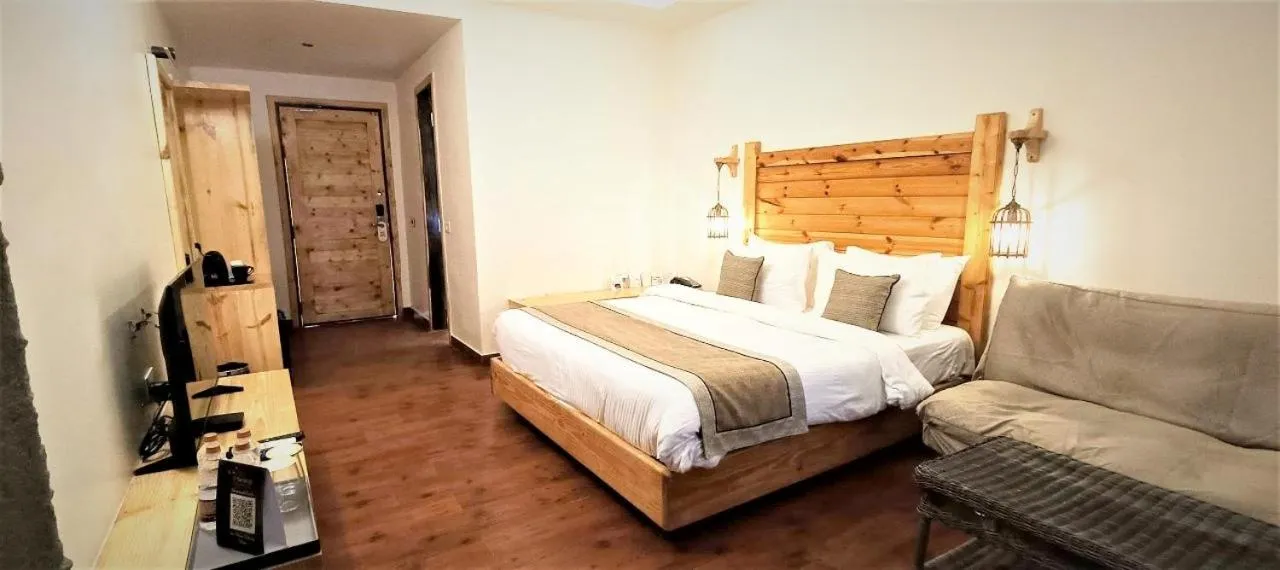 Bed in WelcomHeritage Tarangi Ramganga Resort