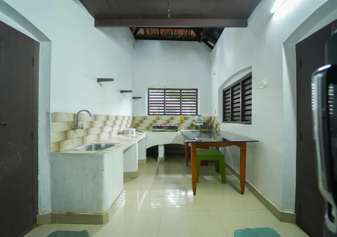 Kitchen or kitchenette in Pop Tavern Private Pool Villa Kovalam by VOYE HOMES