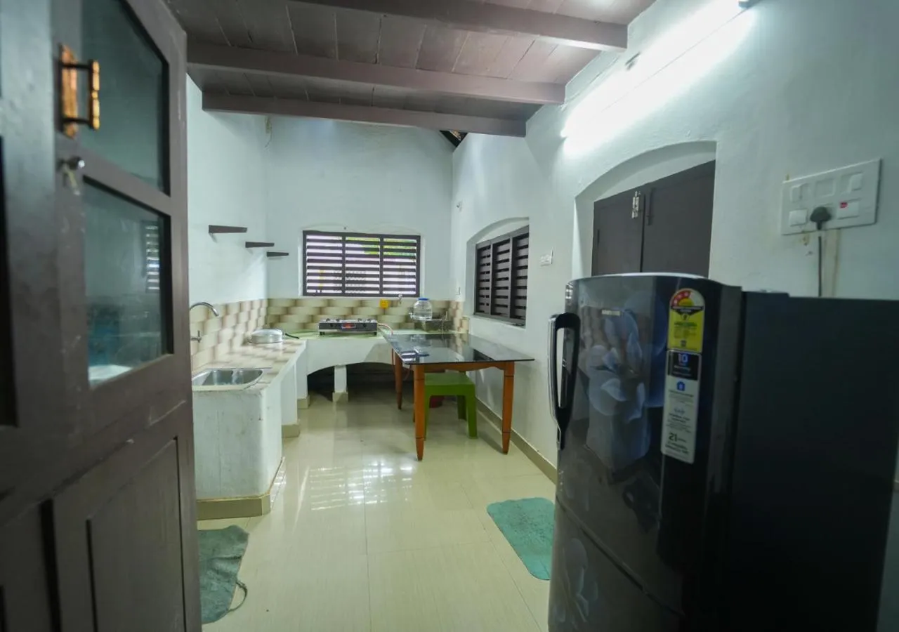 Kitchen or kitchenette in Pop Tavern Private Pool Villa Kovalam by VOYE HOMES