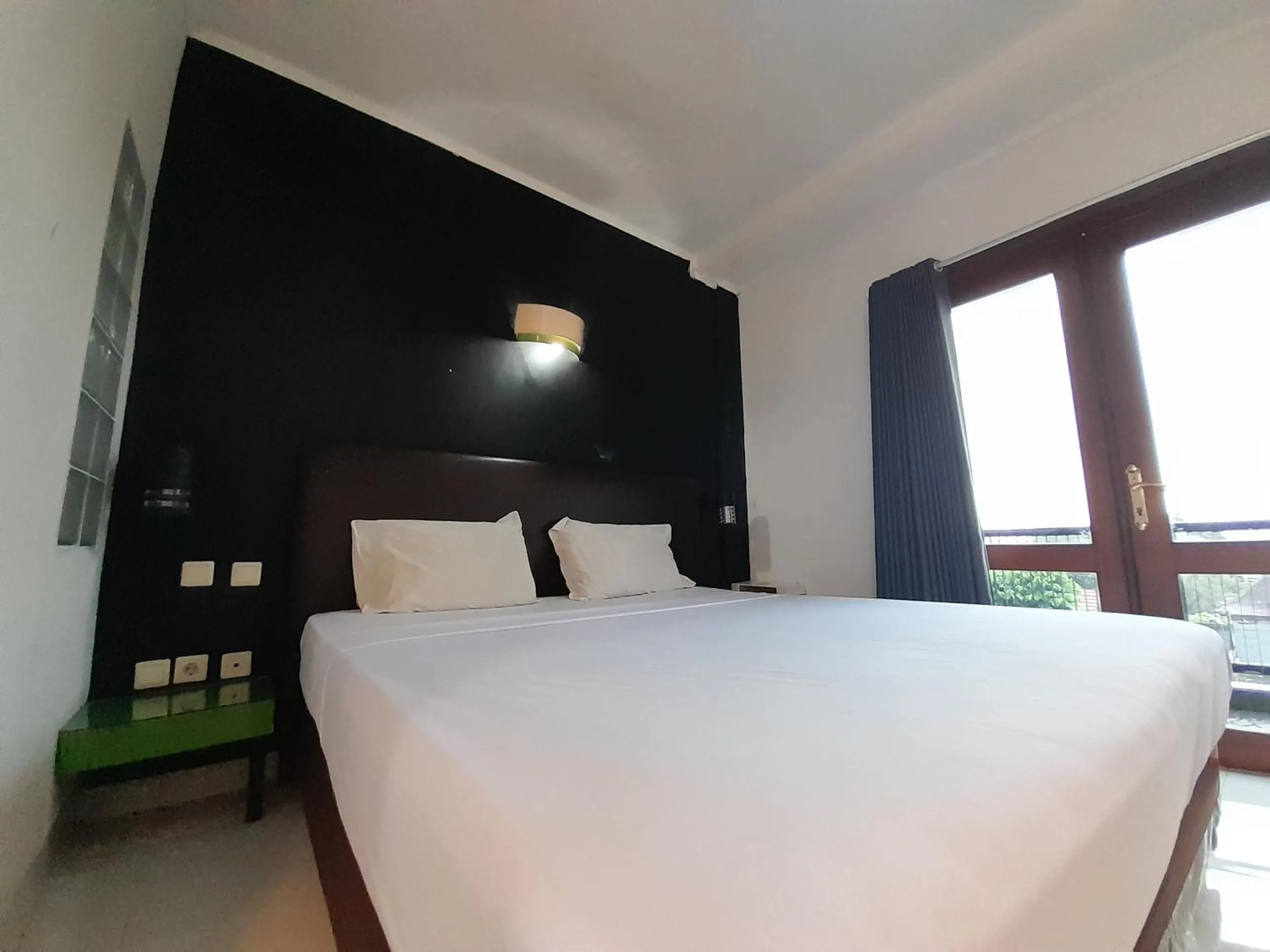 Bed in The Green Winotosastro Hotel Yogyakarta