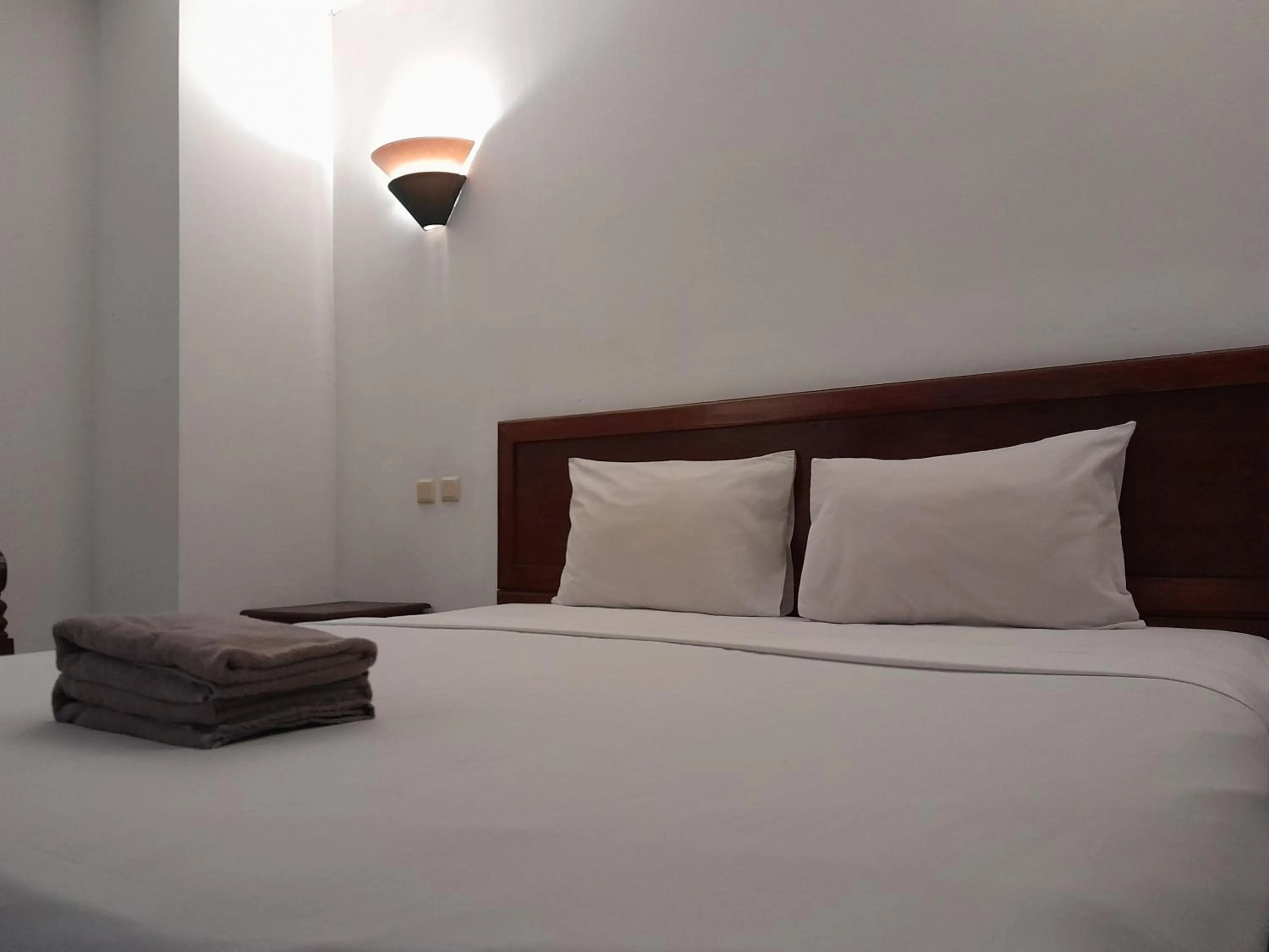 Bed in The Green Winotosastro Hotel Yogyakarta