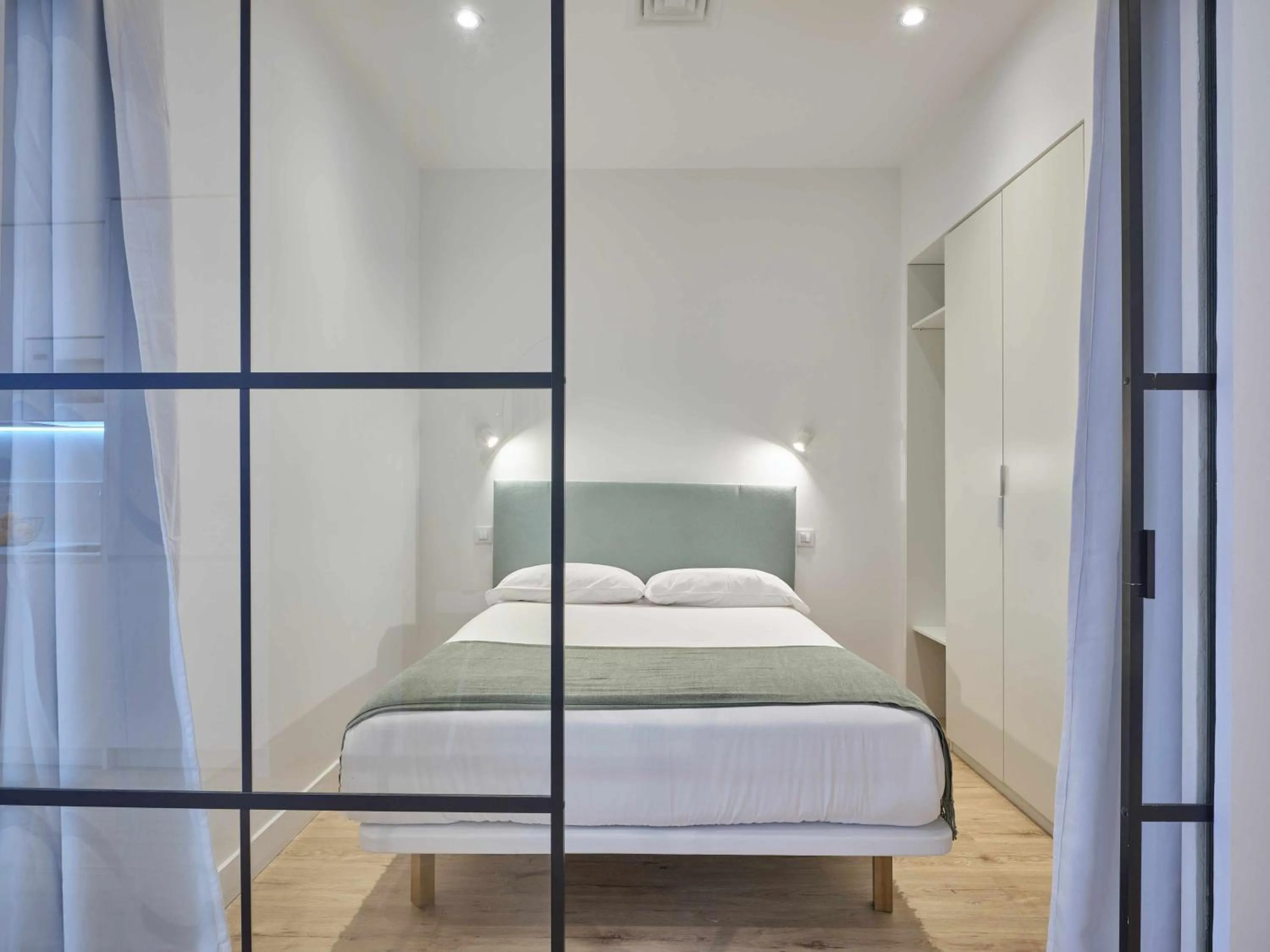 Bed in Paseo Suites Hotel