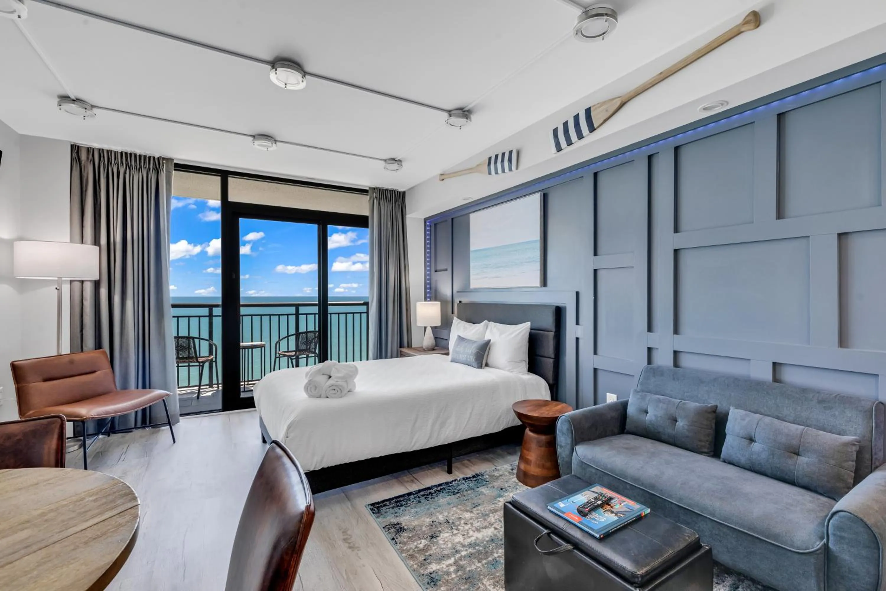 Living room, Bed in Breakers Tower 1BR Oceanfront Condo