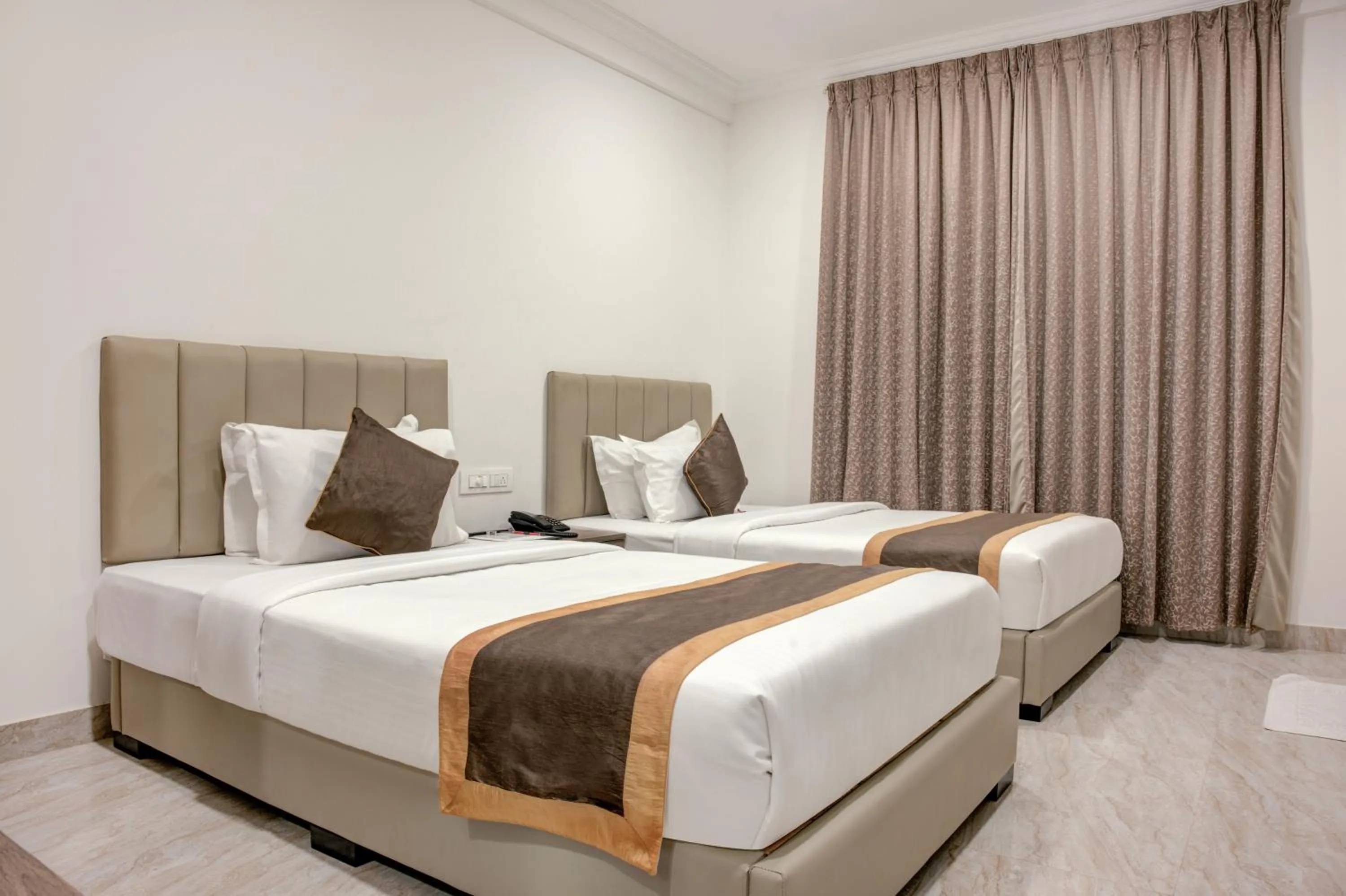Photo of the whole room, Bed in Hotel Sterling Inn Bangalore International Airport