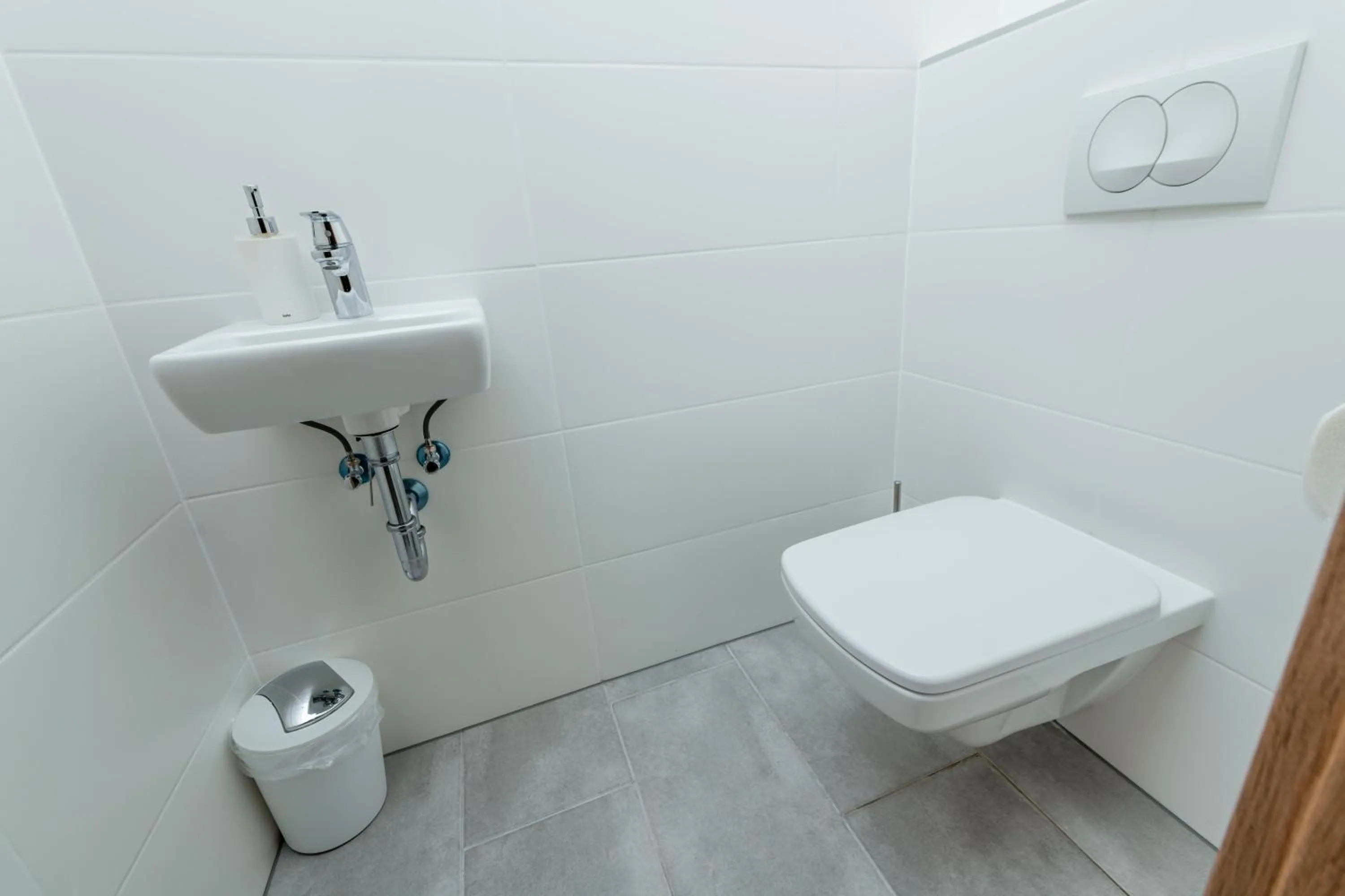 Toilet in WestSide Apartments by FirstHost