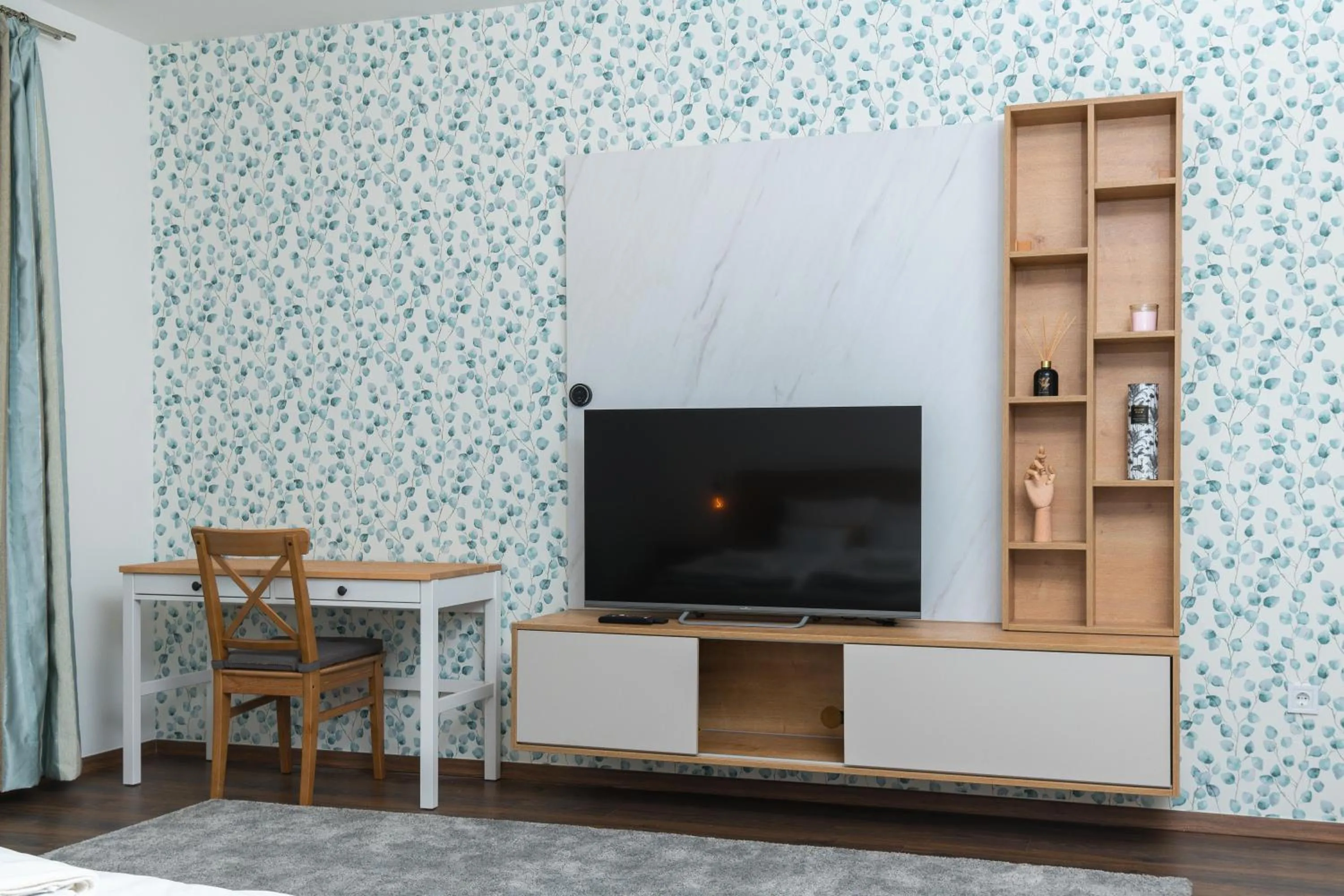 Communal lounge/ TV room in WestSide Apartments by FirstHost