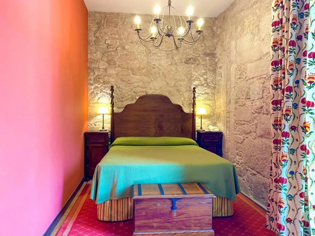 Bed in Hotel Pazo de Lestrove by Pousadas de Compostela