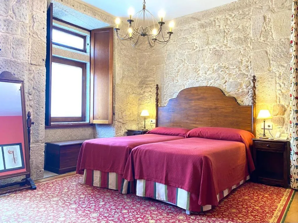 Bed in Hotel Pazo de Lestrove by Pousadas de Compostela