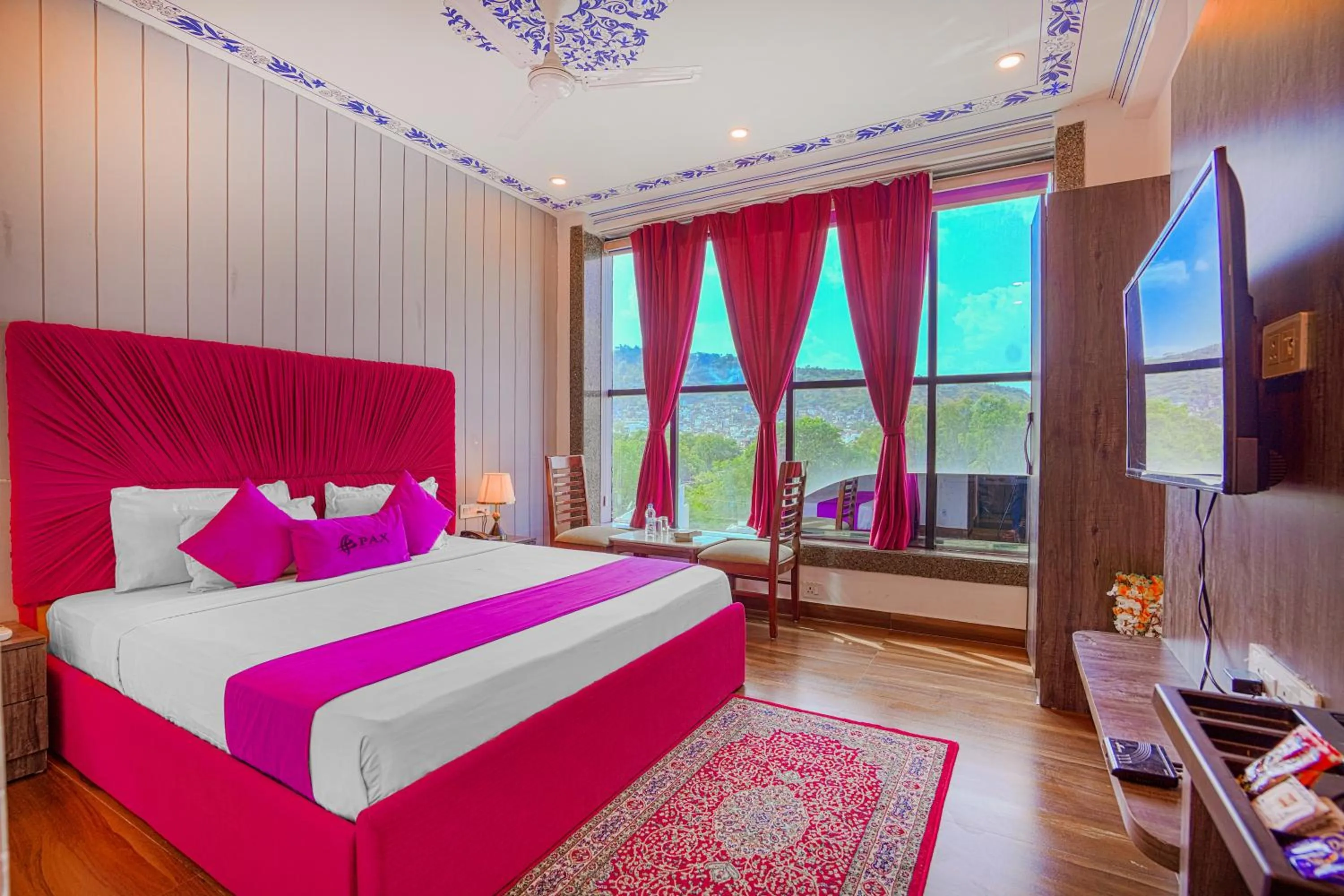 Photo of the whole room, Bed in Pax Hotel Grand Blue 3 min walk from Udaipur city Railway Station