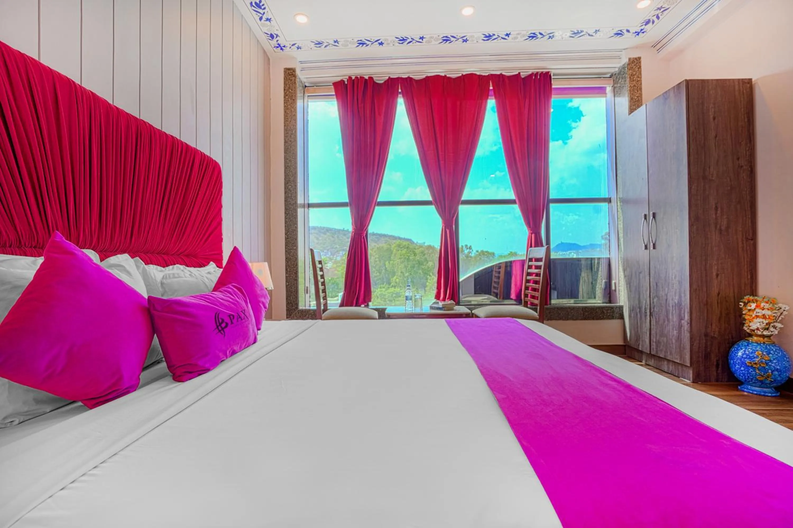 Photo of the whole room, Bed in Pax Hotel Grand Blue 3 min walk from Udaipur city Railway Station