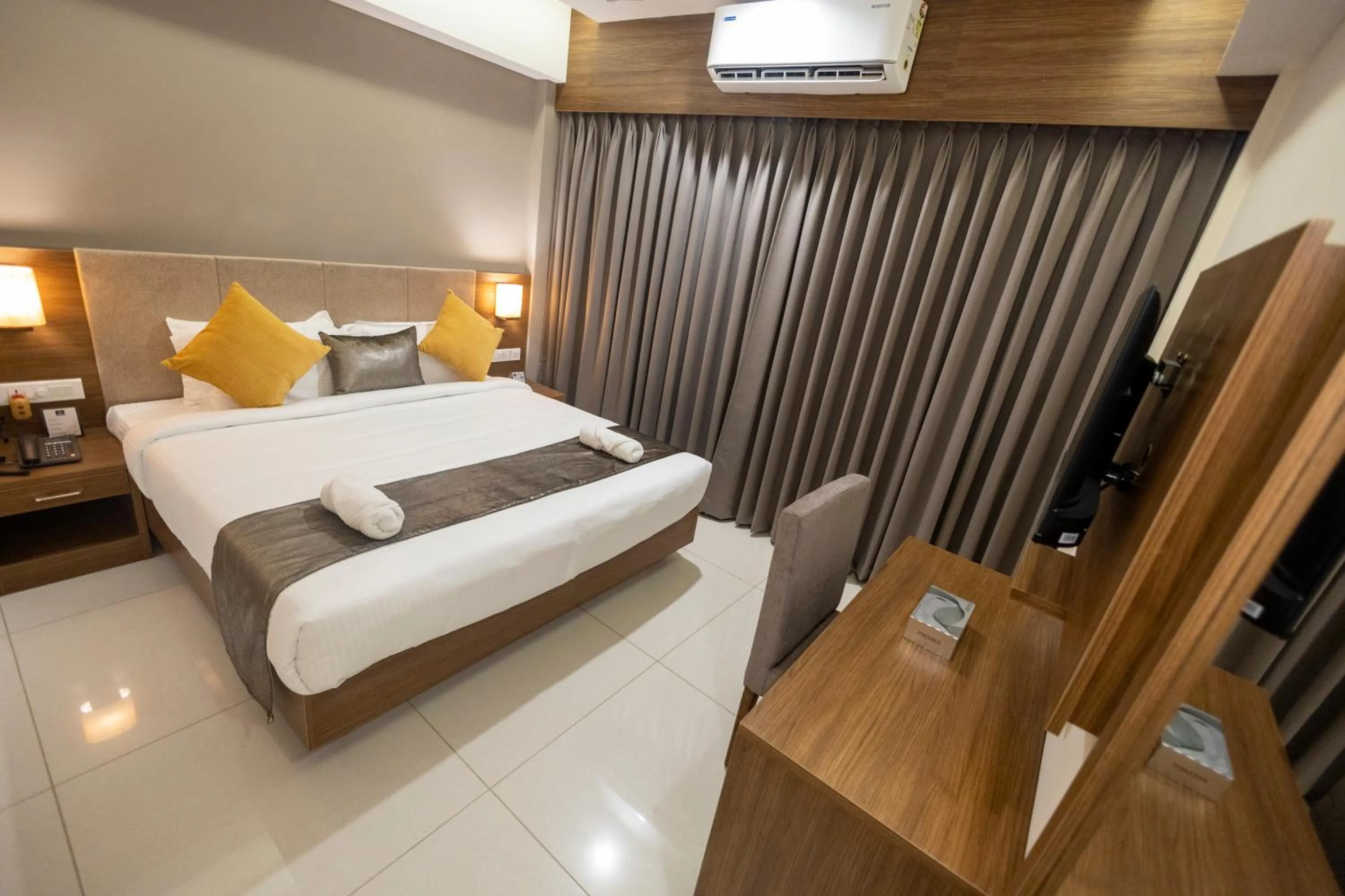 Bed in Hotel Kottayam Grand