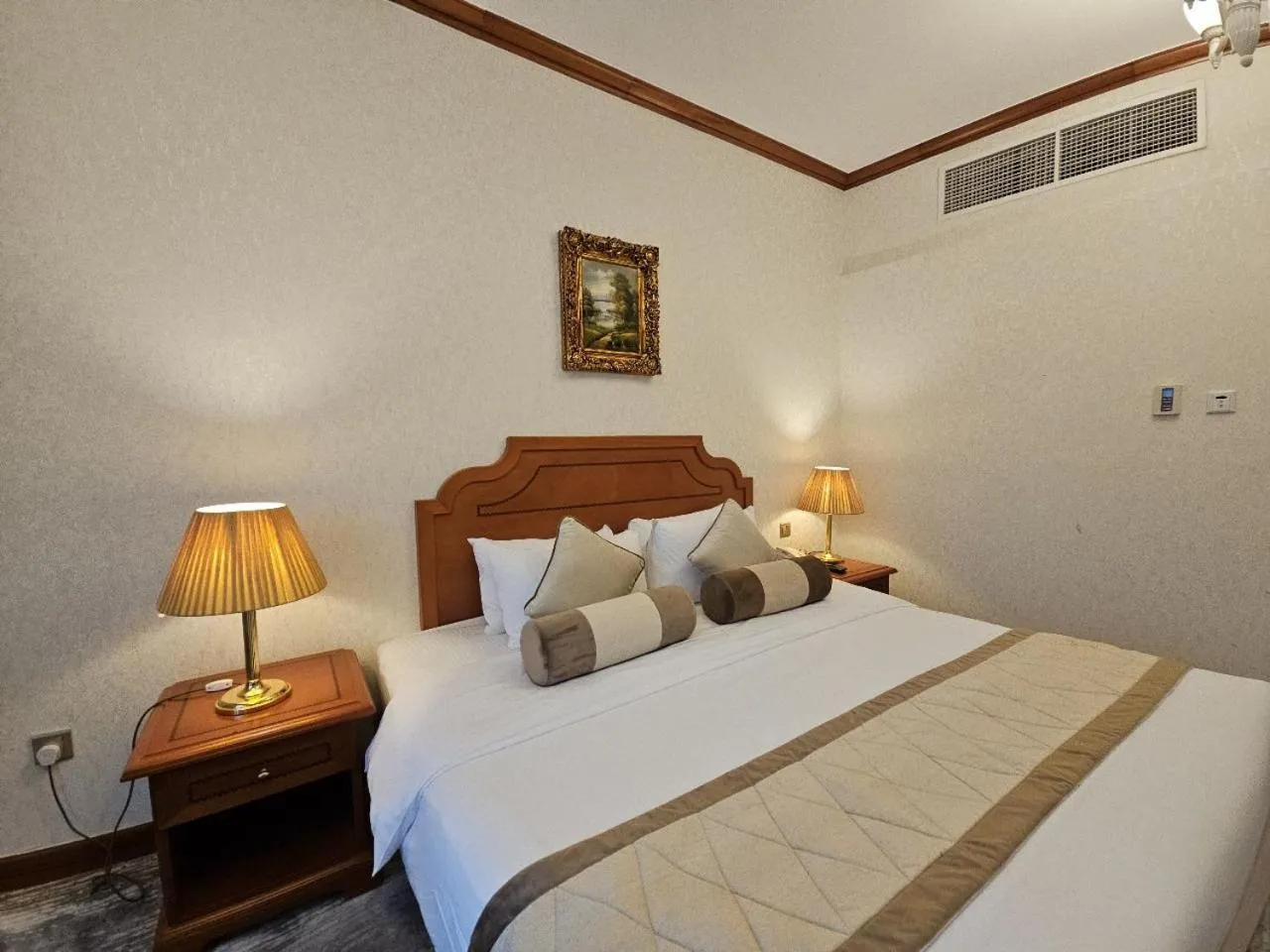 Bed in Royal Concorde Hotel & Suite