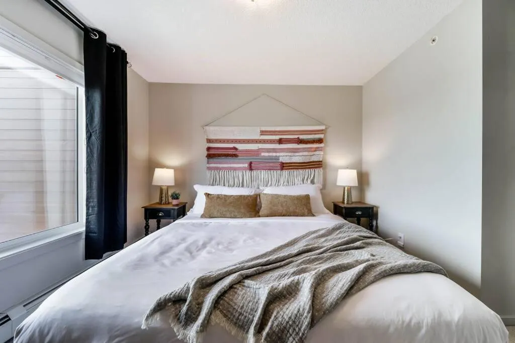 Bed in Bright Luxe Condo, AC, Top Floor, King Bed, Balcony!