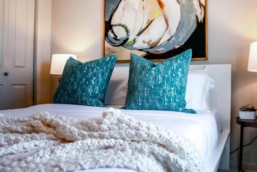 Bed in Bright Luxe Condo, AC, Top Floor, King Bed, Balcony!