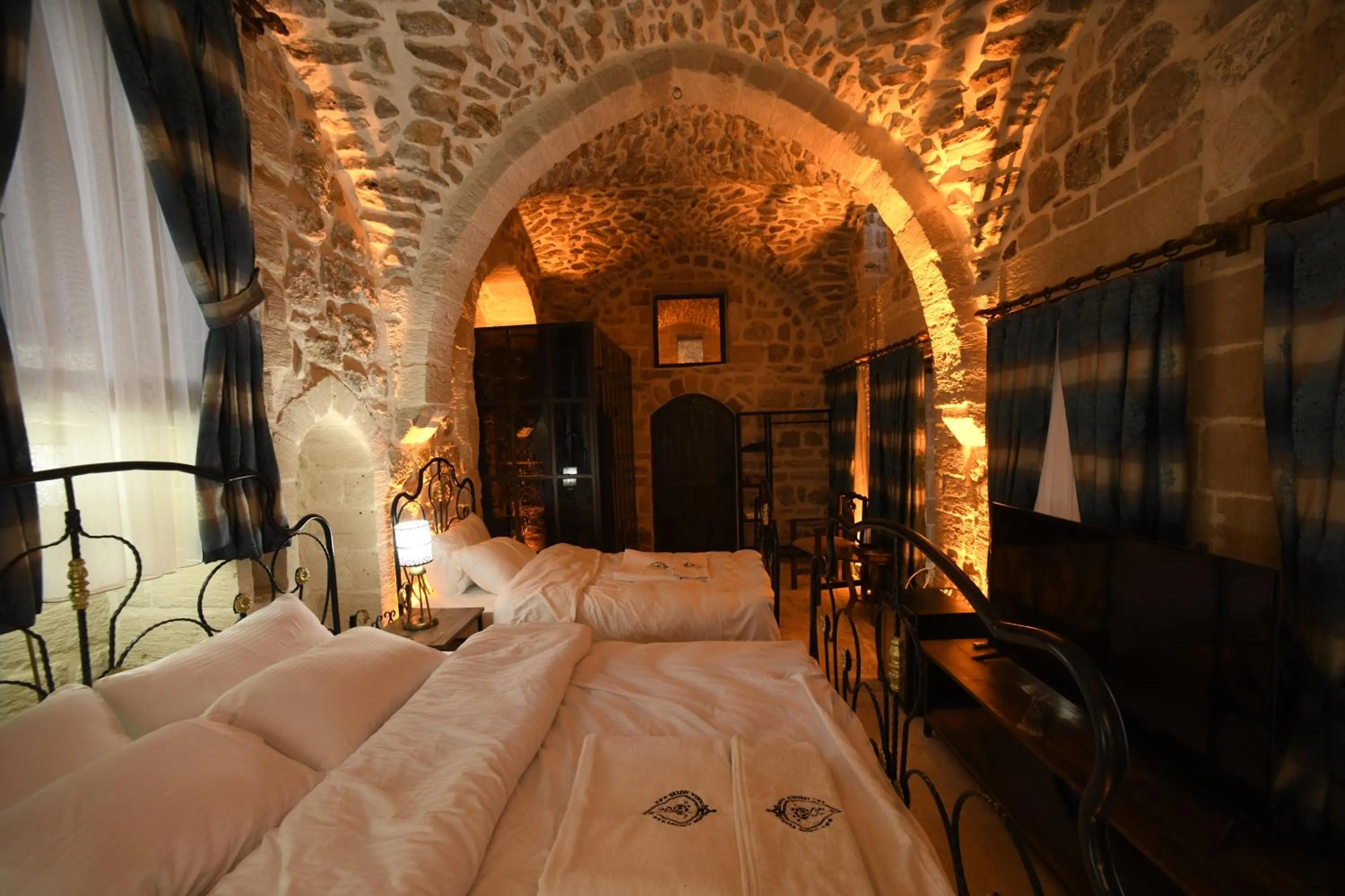 Bed in Legacy Mesopotamia Hotel