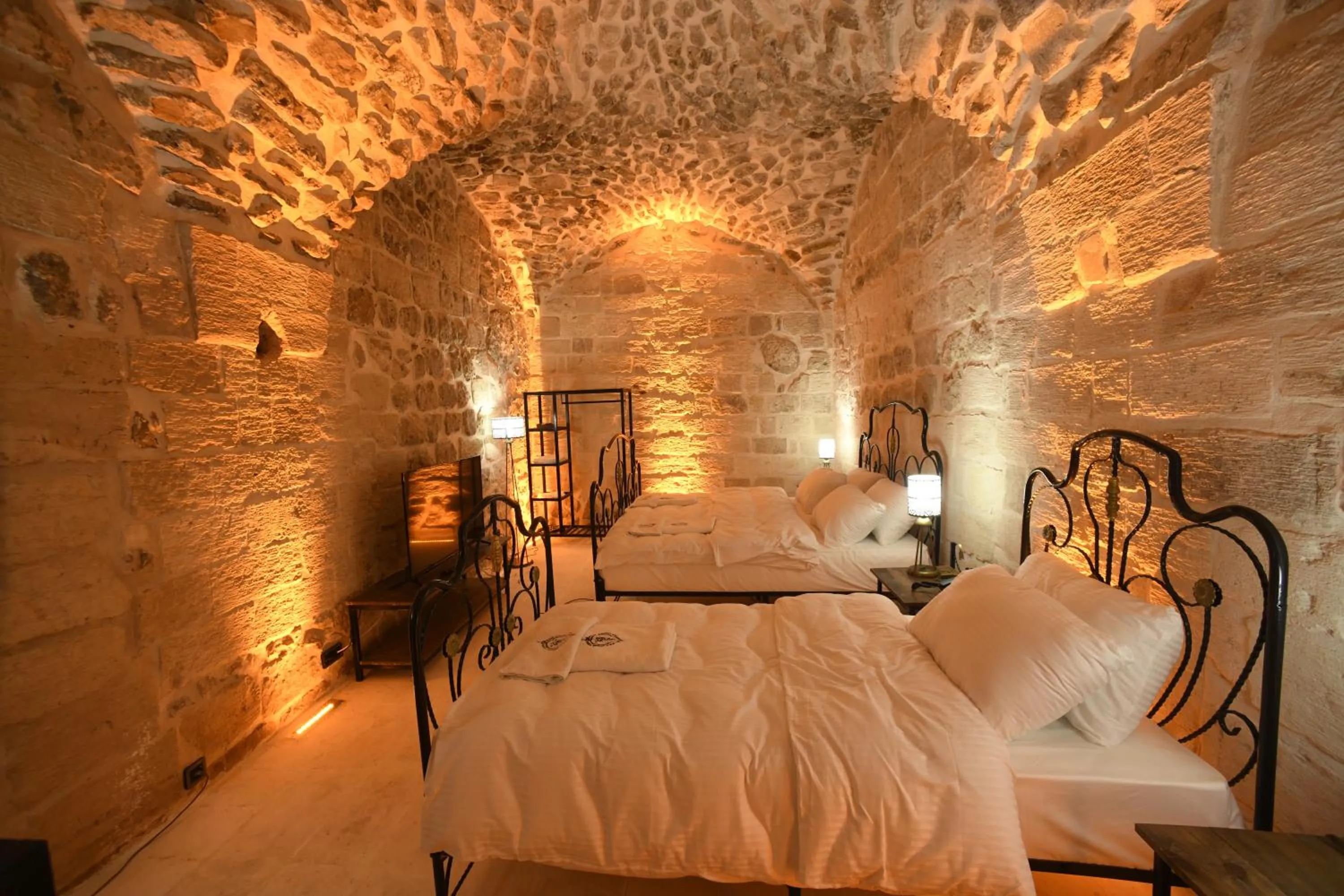 Bed in Legacy Mesopotamia Hotel