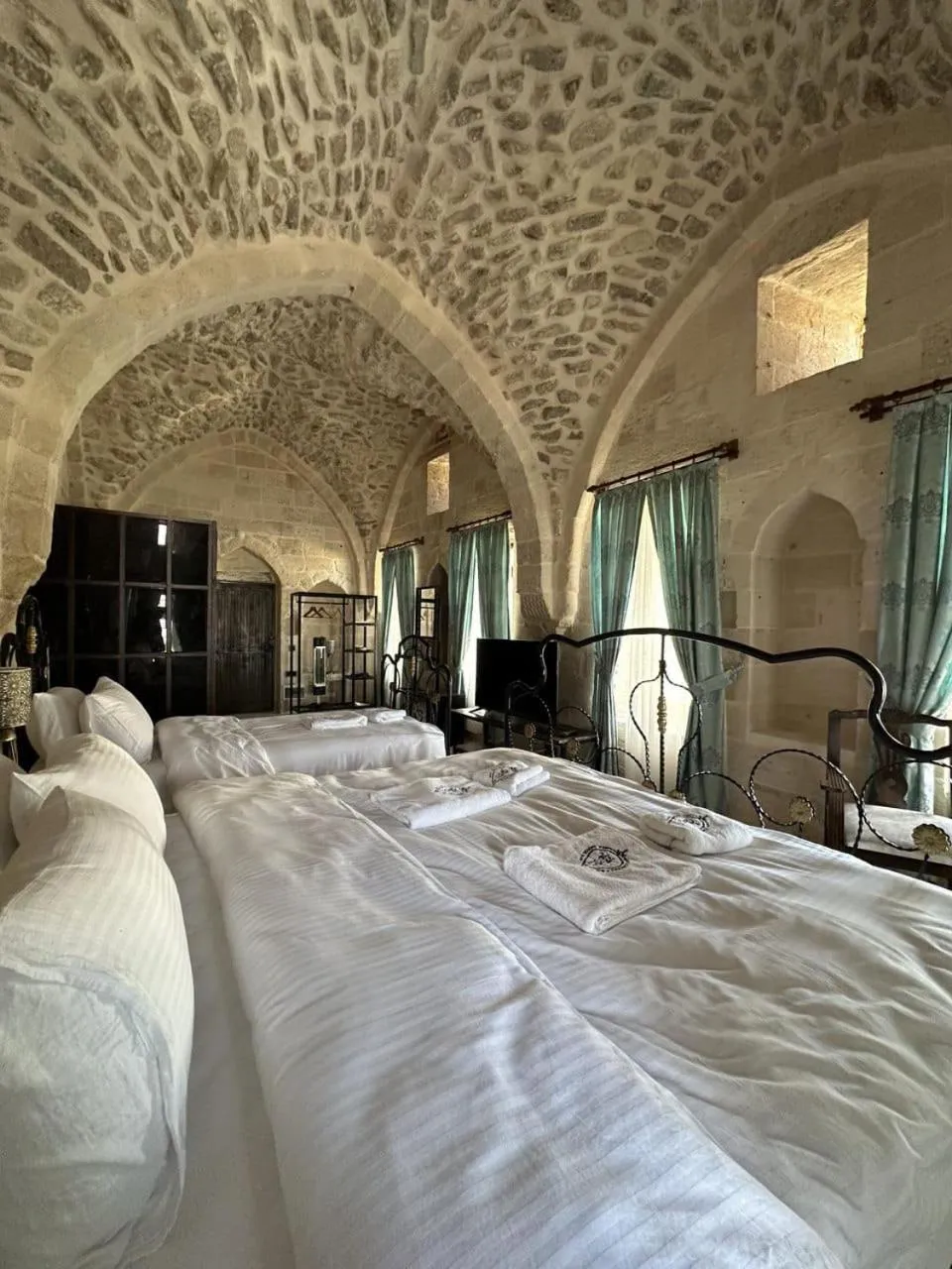 Bed in Legacy Mesopotamia Hotel