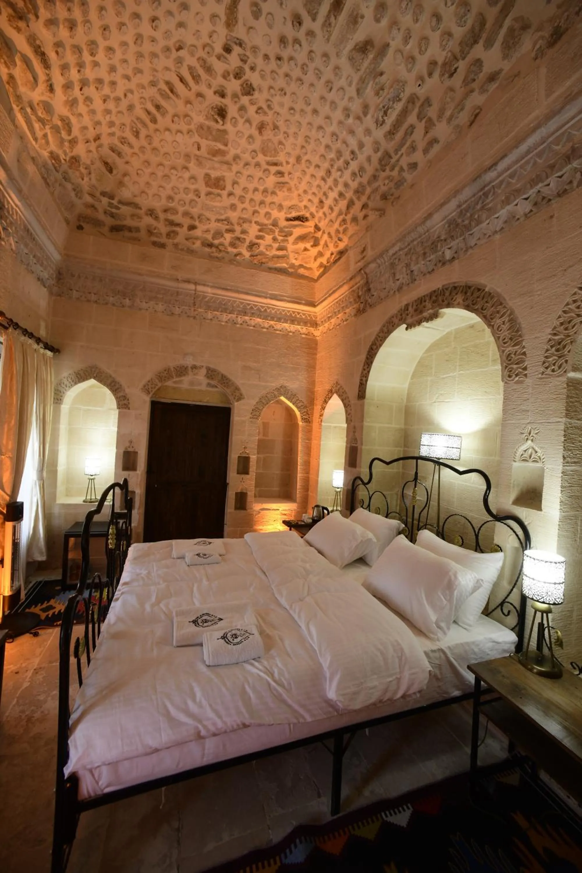 Bed in Legacy Mesopotamia Hotel