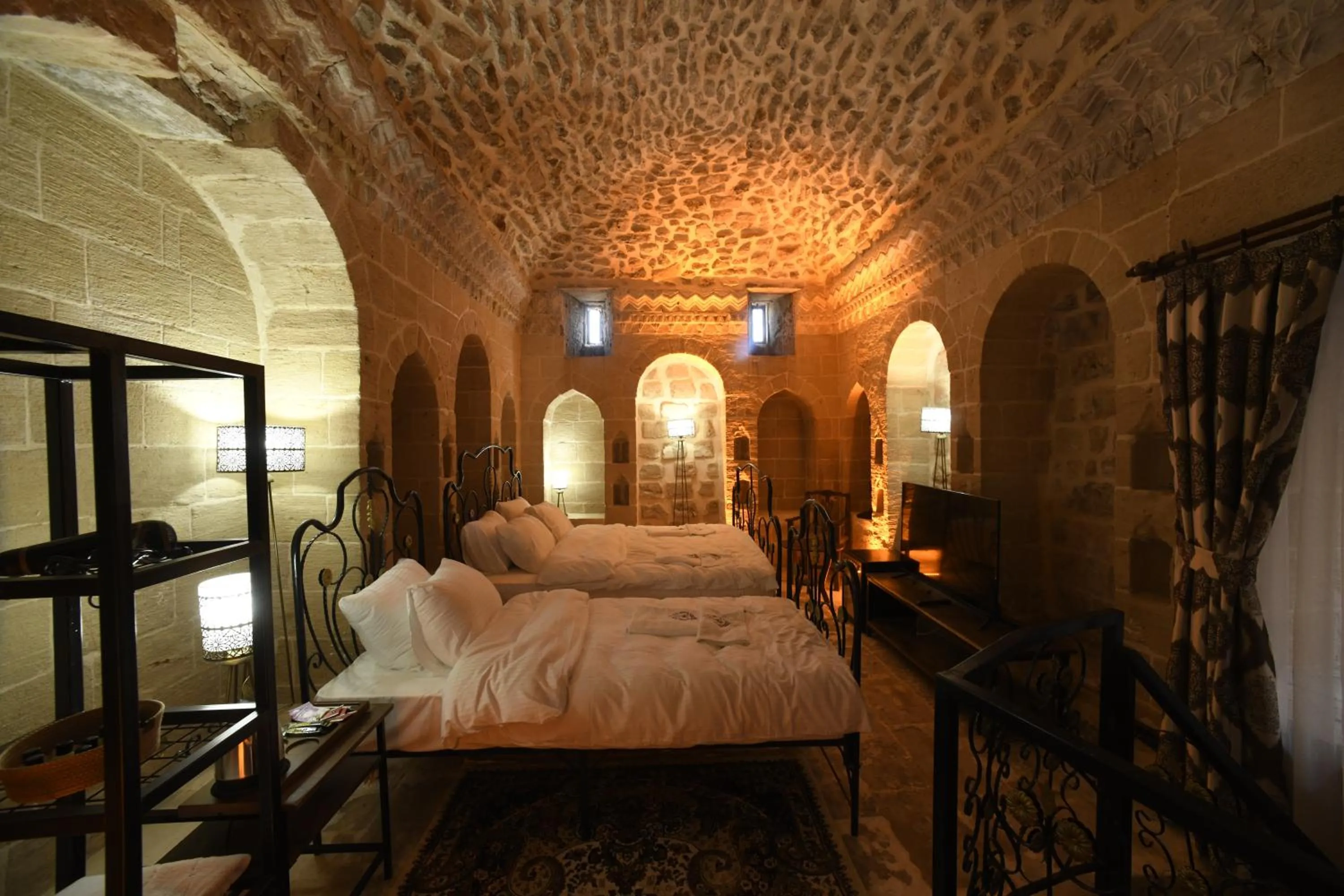 Bed in Legacy Mesopotamia Hotel