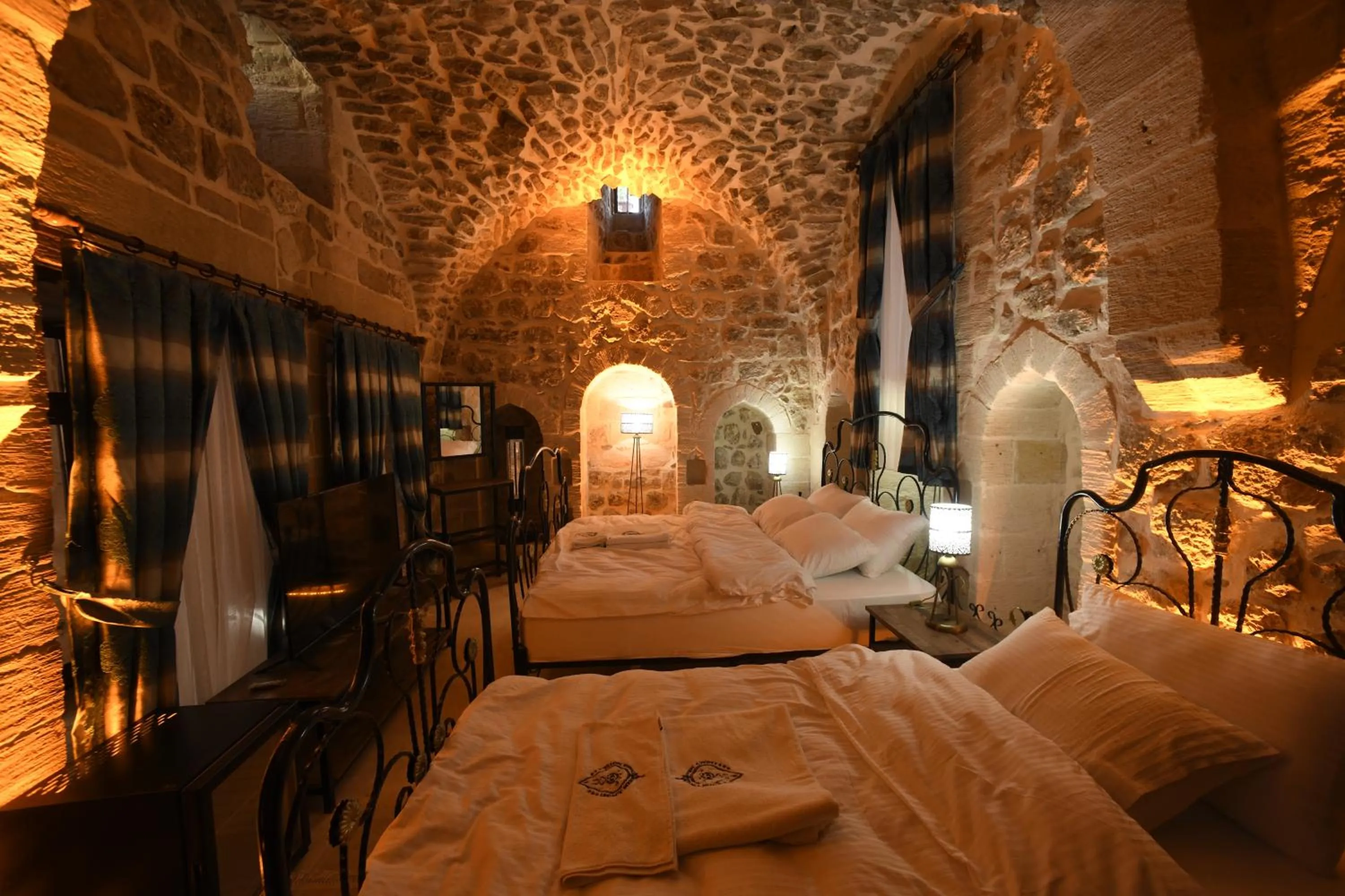 Bed in Legacy Mesopotamia Hotel