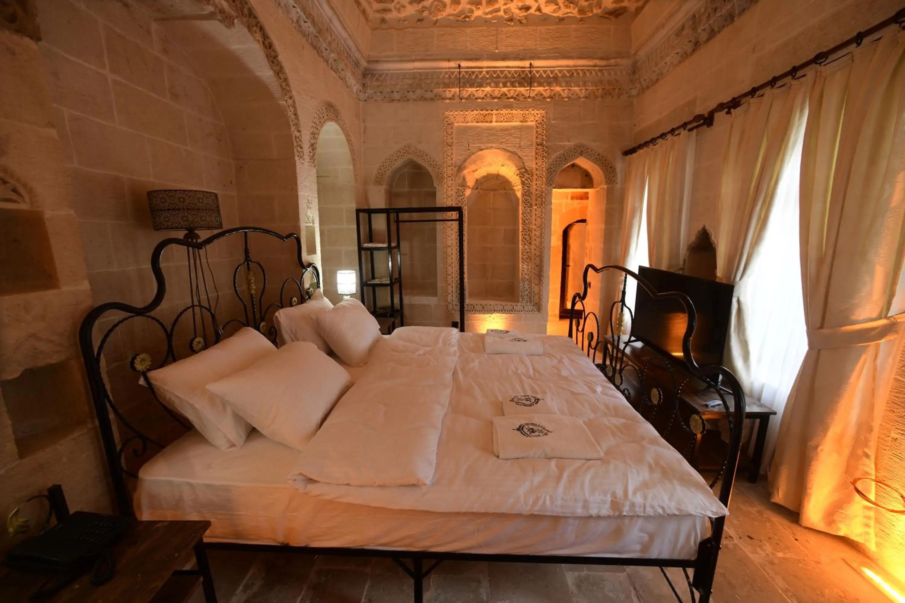 Bed in Legacy Mesopotamia Hotel