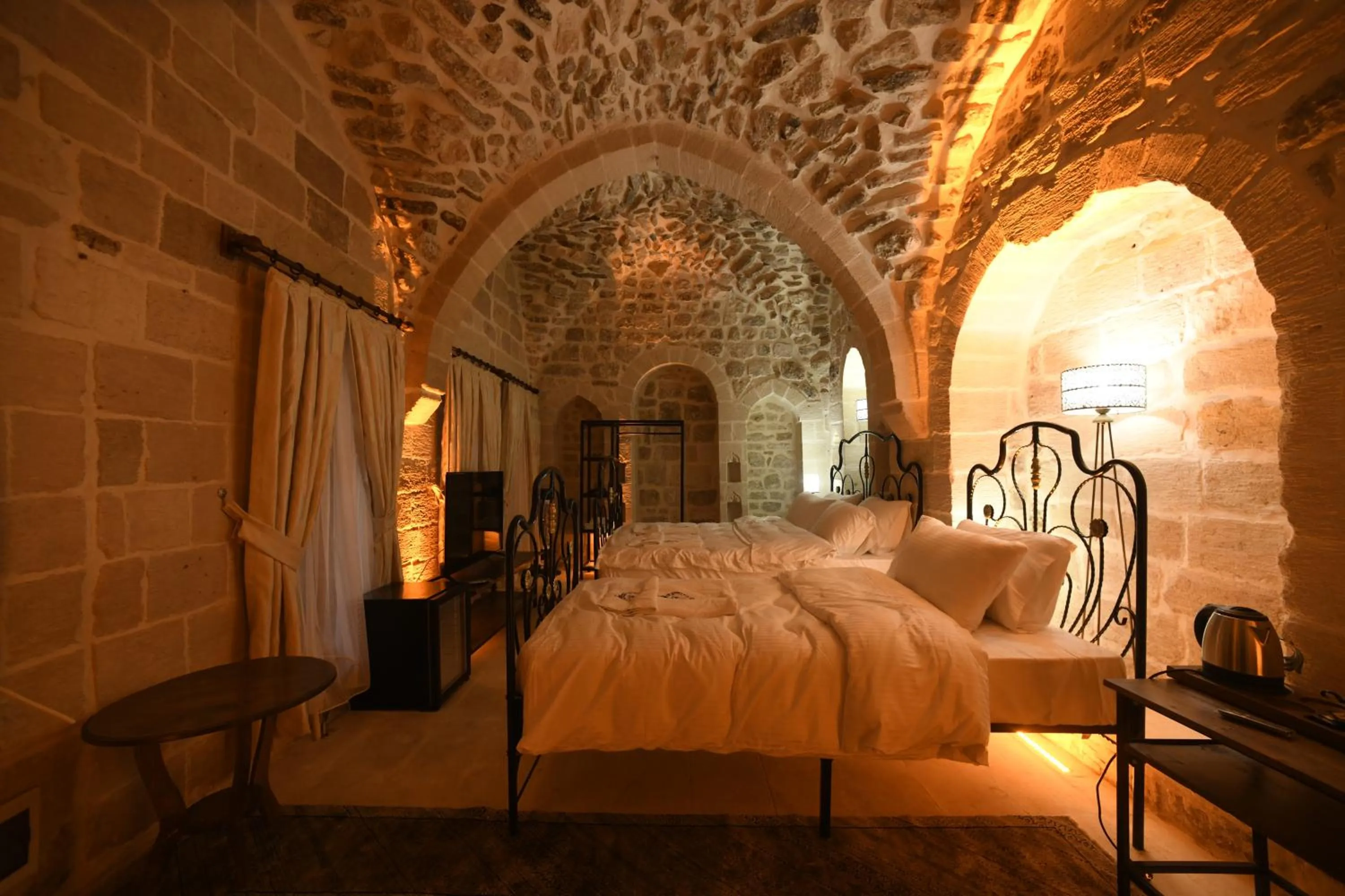 Bed in Legacy Mesopotamia Hotel