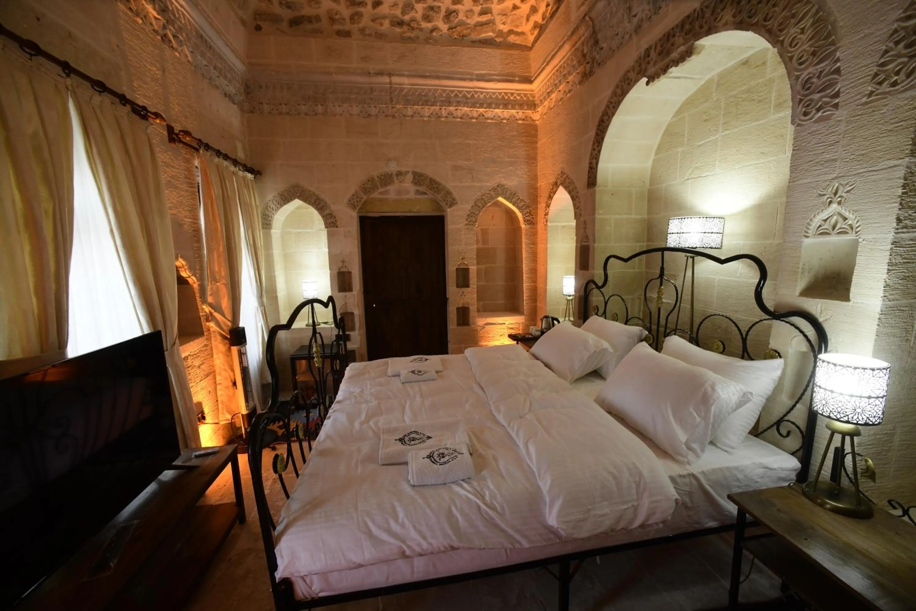 Bed in Legacy Mesopotamia Hotel