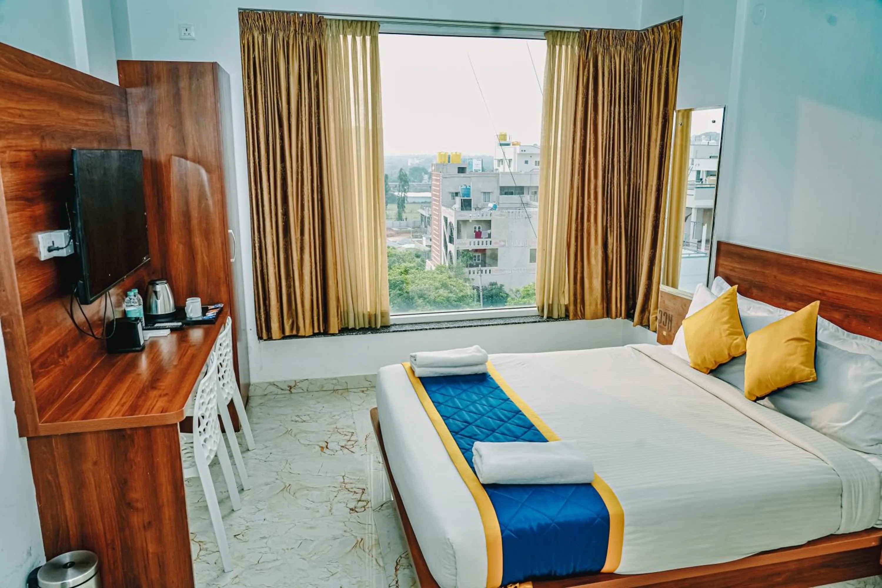 Photo of the whole room, Bed in Keerthis Royal Suites -Bangalore Airport Budget Luxury Hotel