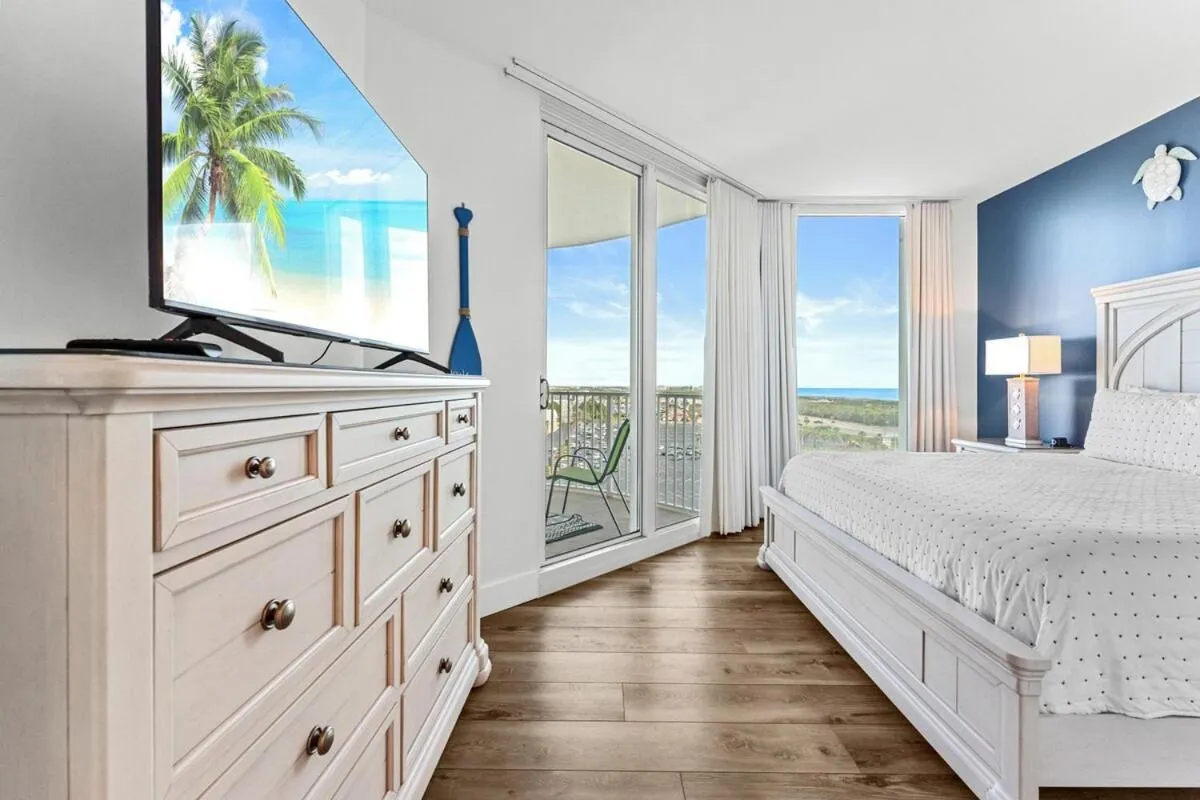 Bed in Sunrise Surprise 9th floor 2BR 2 BA King Suite Beach shuttle, heated pool!