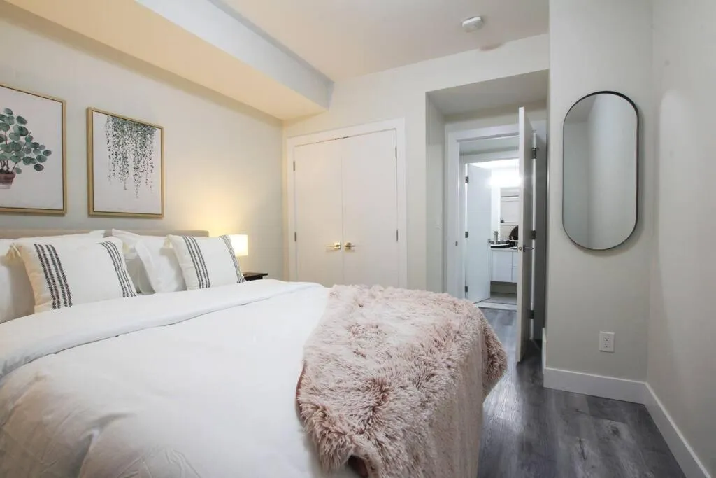 Photo of the whole room, Bed in Executive Bsmt Suite, King Bed, 5 min to DT & Whyte Ave, Sleeps 6!