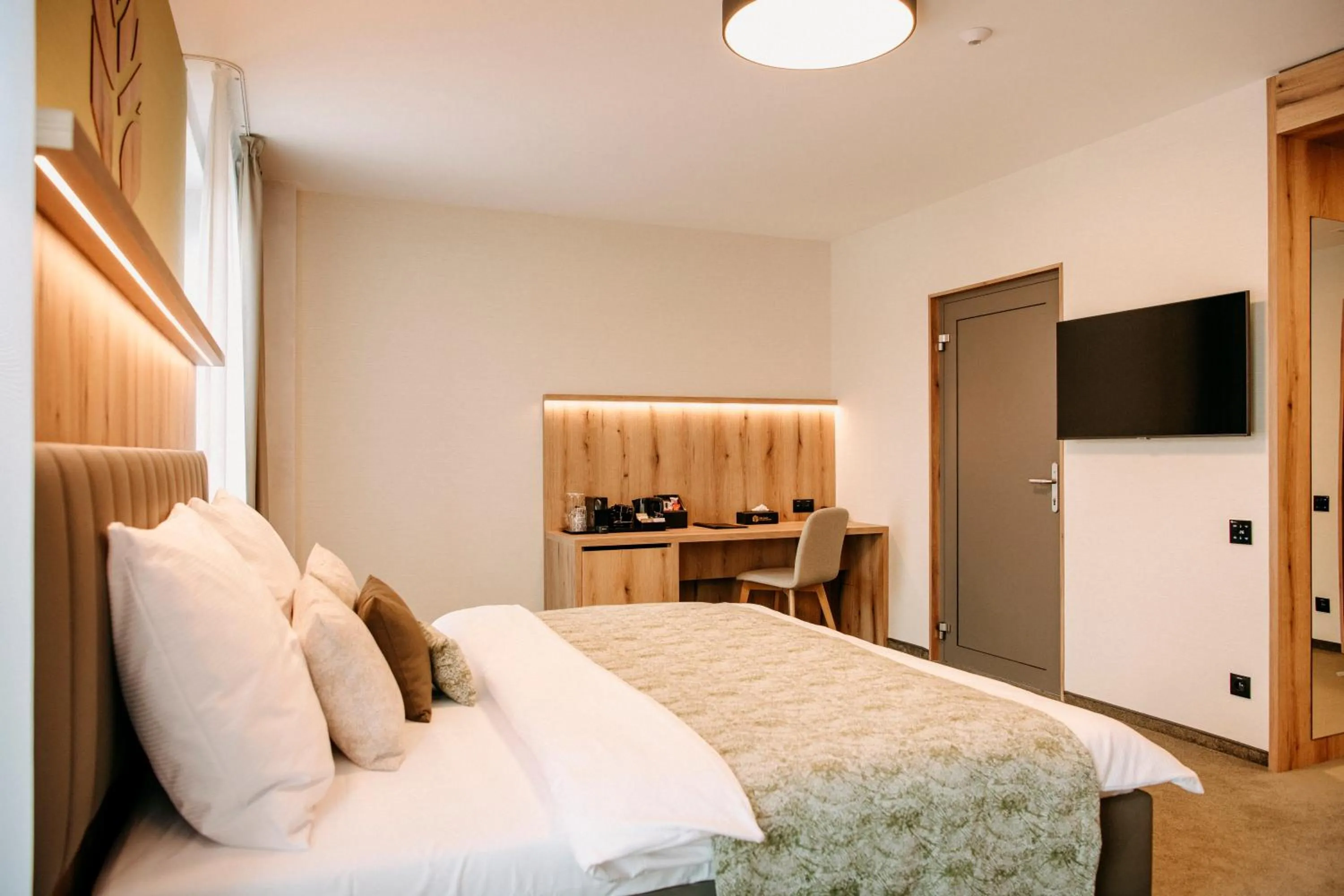 Living room, Bed in RM Hotel Wellness & Congress