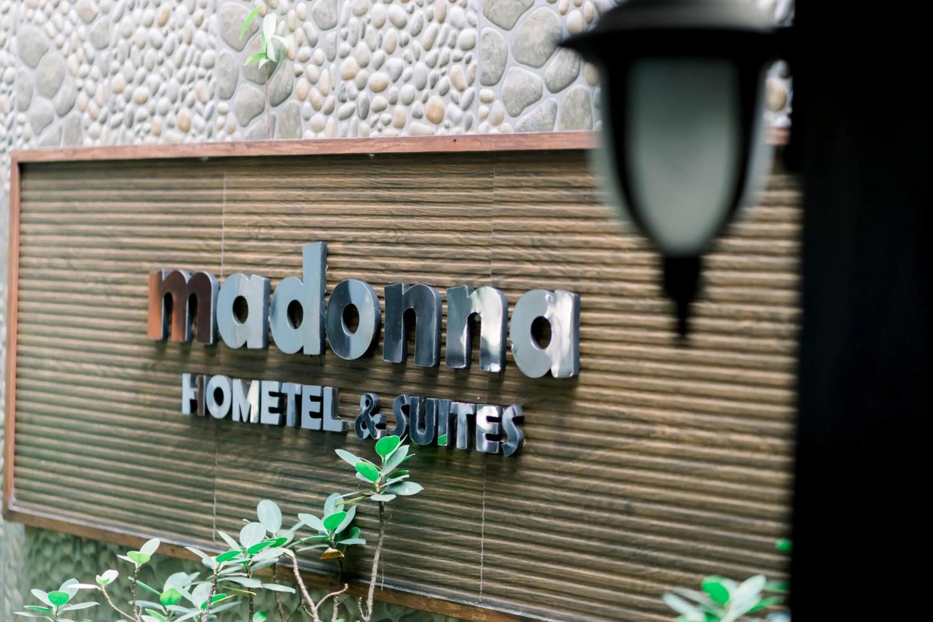 Property logo or sign in Madonna Hometel and Suites