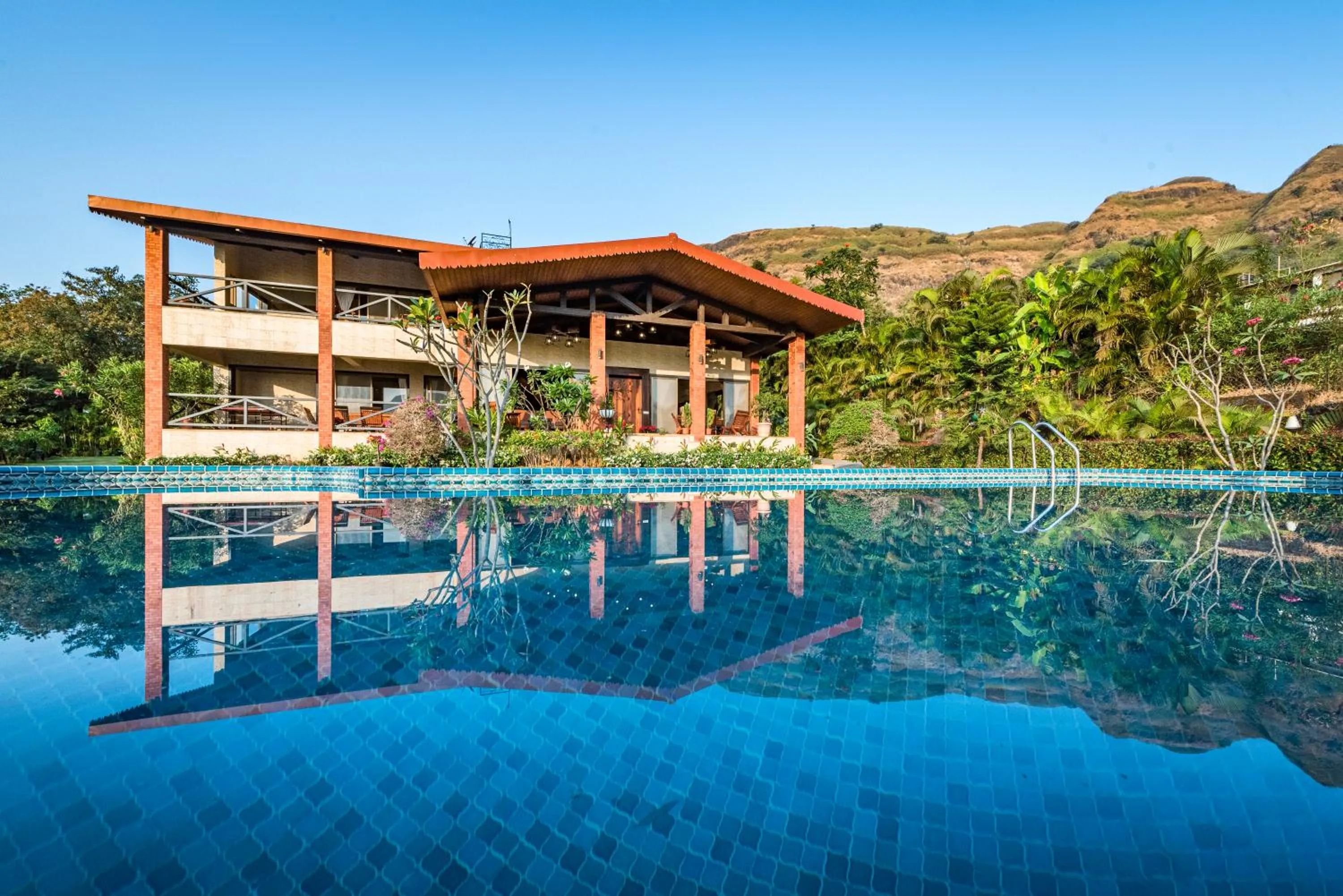 SaffronStays Althea - 4BR veg-only luxury villa with pool, jacuzzis, gourmet meals and Lohagad-Pawna lake views