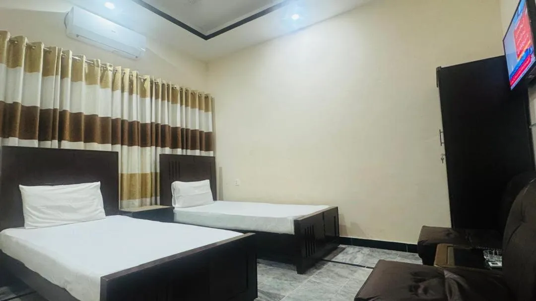 Bed in New Palace Guest House